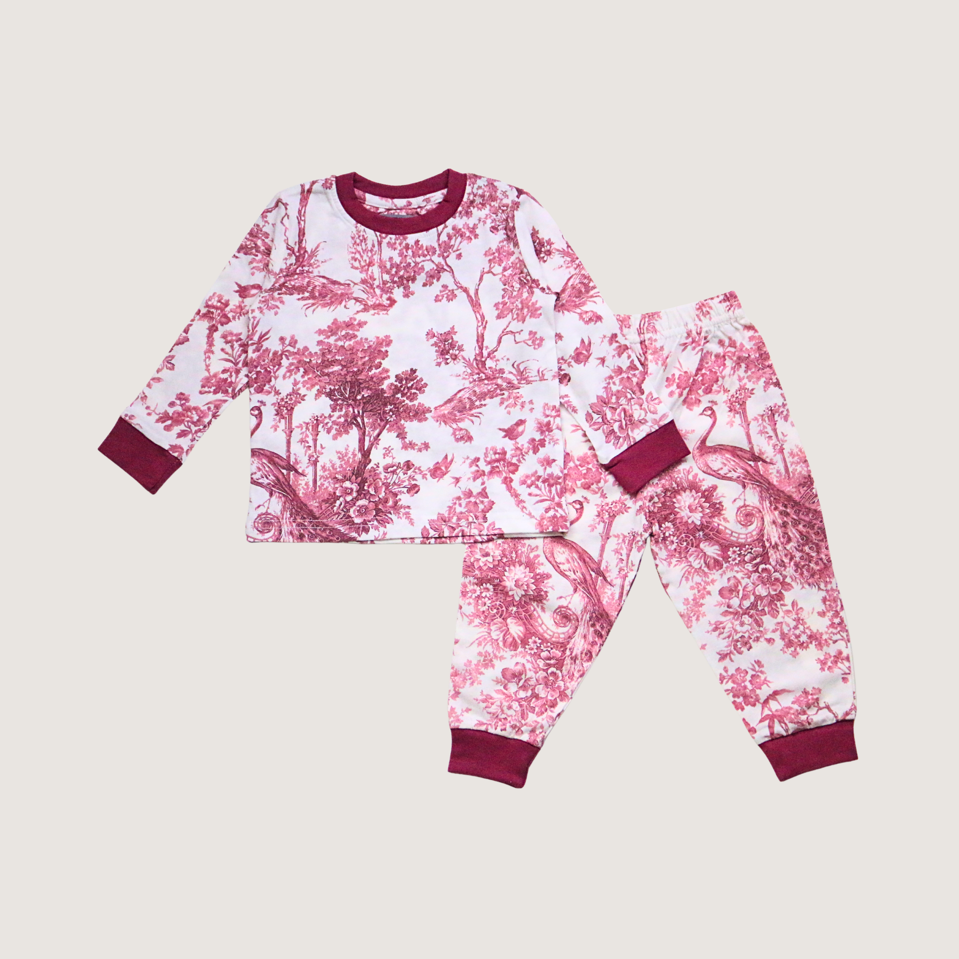 Children's pajama set with pink floral pattern on a beige background