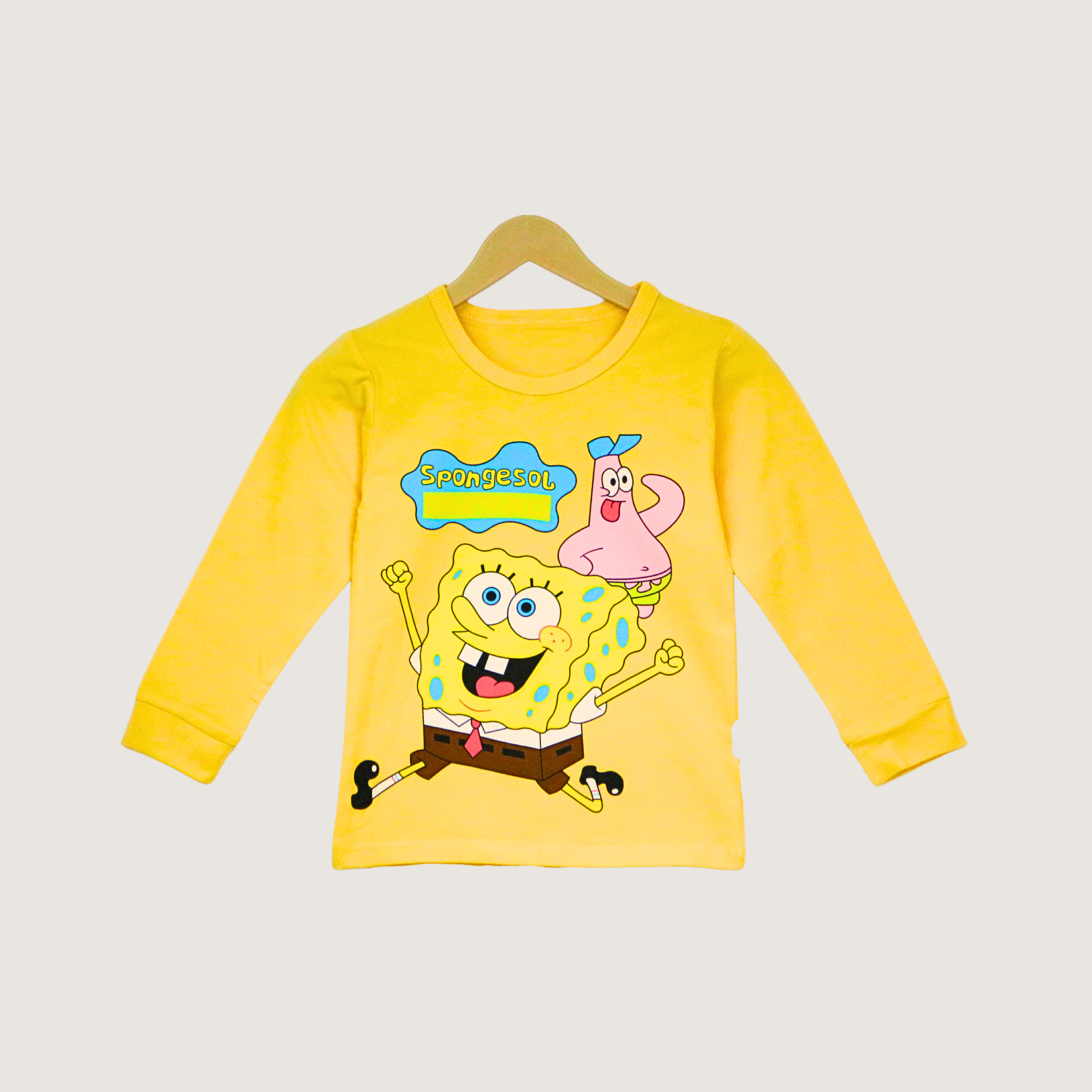 Yellow long-sleeve shirt with SpongeBob SquarePants design on a hanger against a light gray background