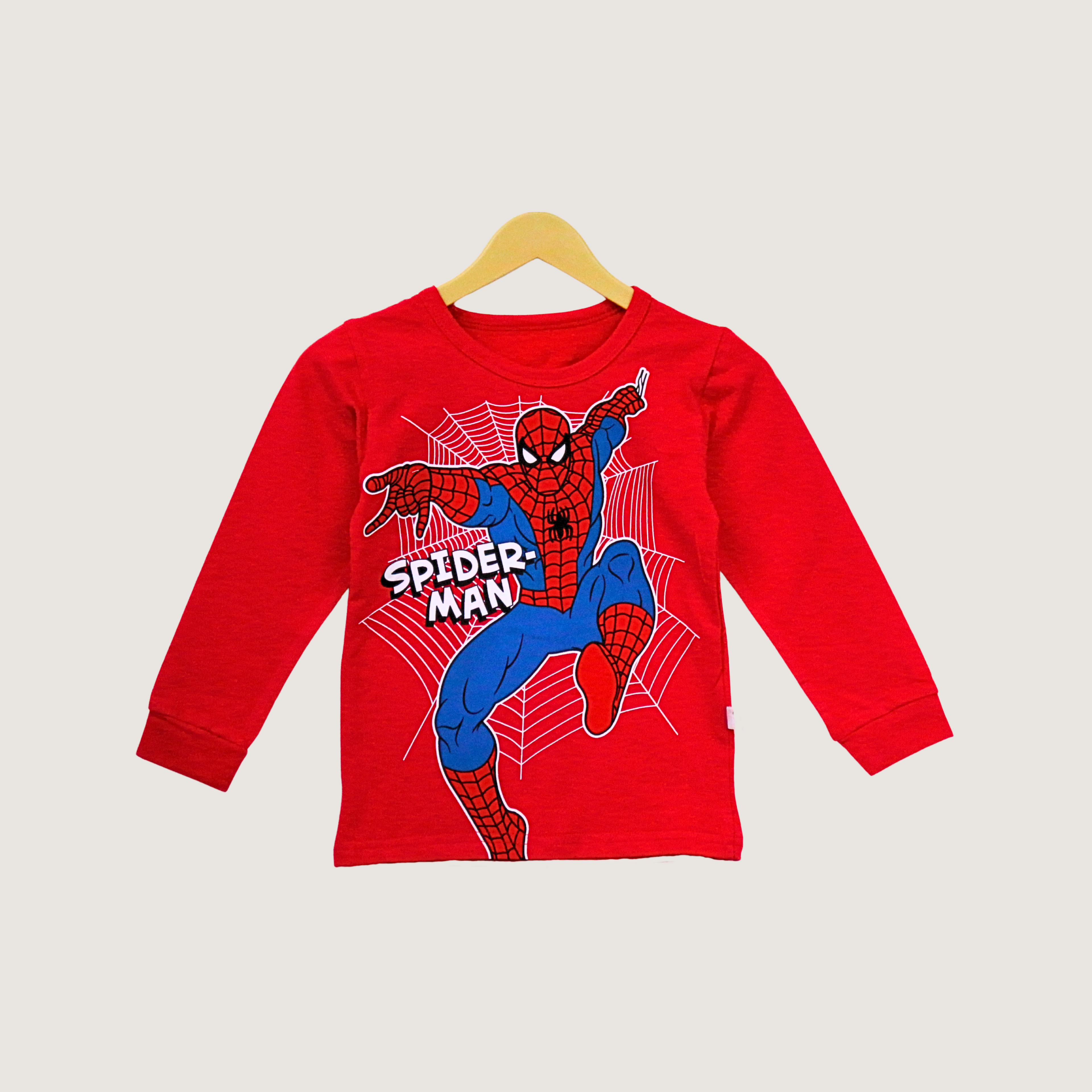 Red long-sleeve shirt with Spider-Man graphic on a beige background