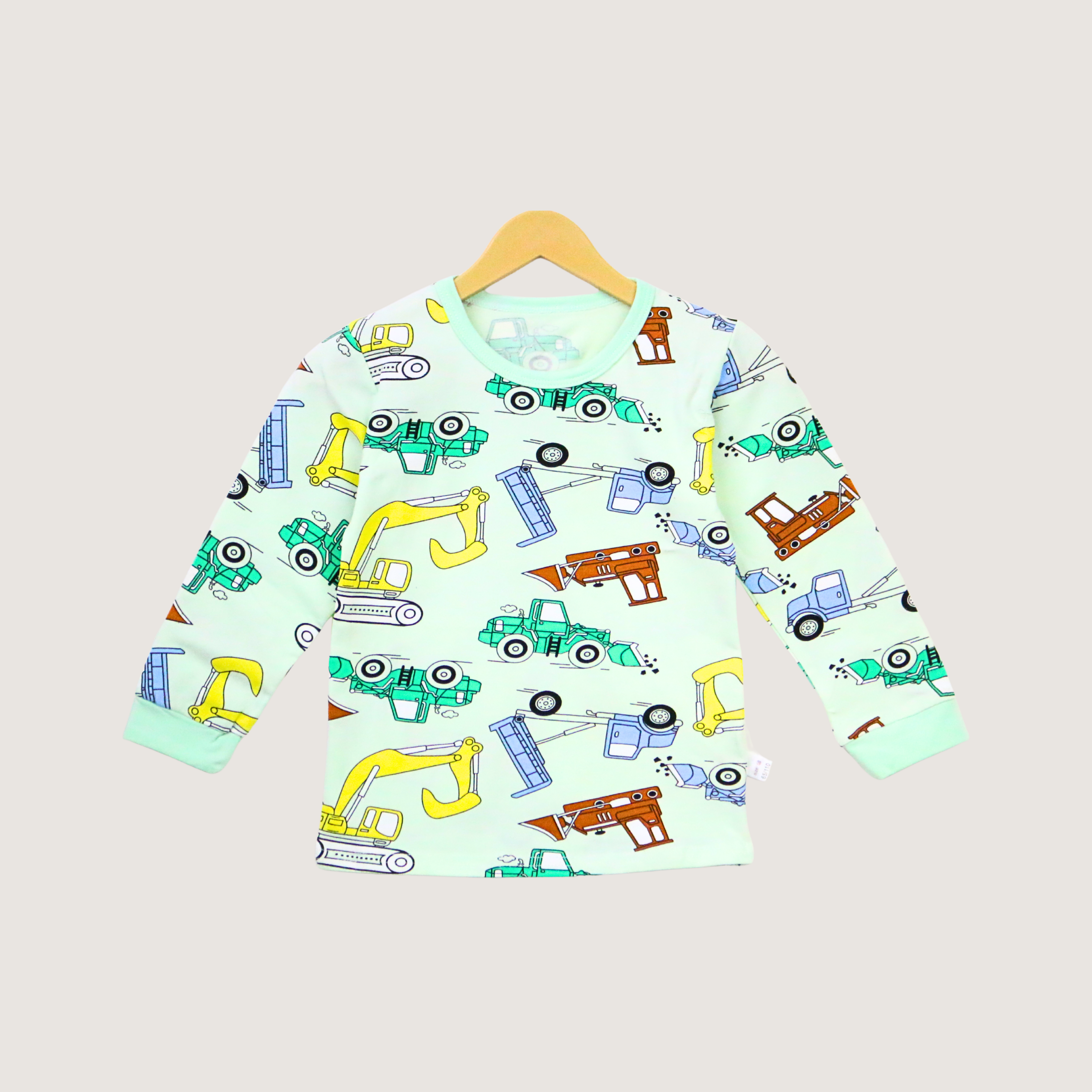Children's long-sleeve shirt with construction vehicle pattern on a hanger against a light gray background