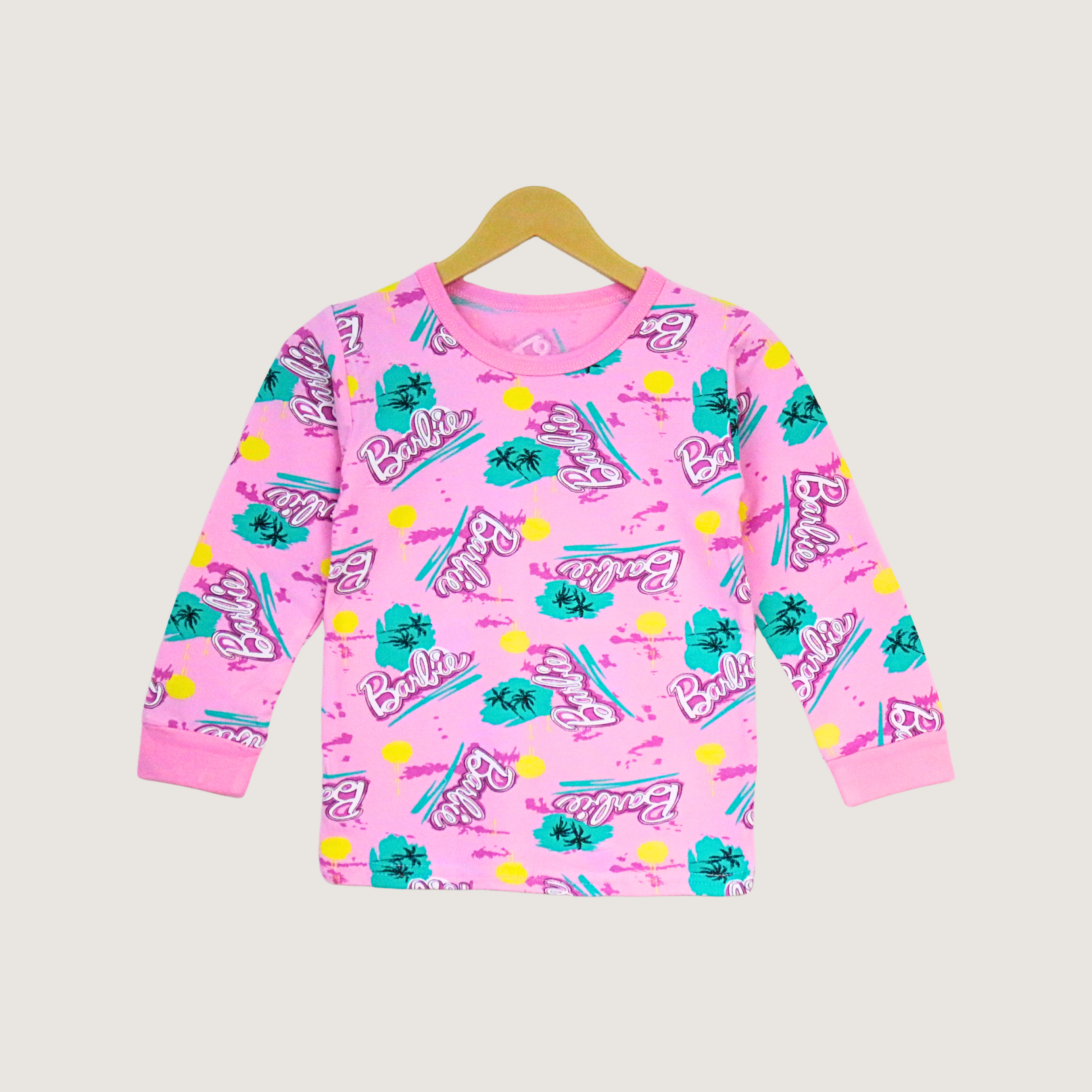 Pink children's sweatshirt with Barbie logo and graphics on a beige background