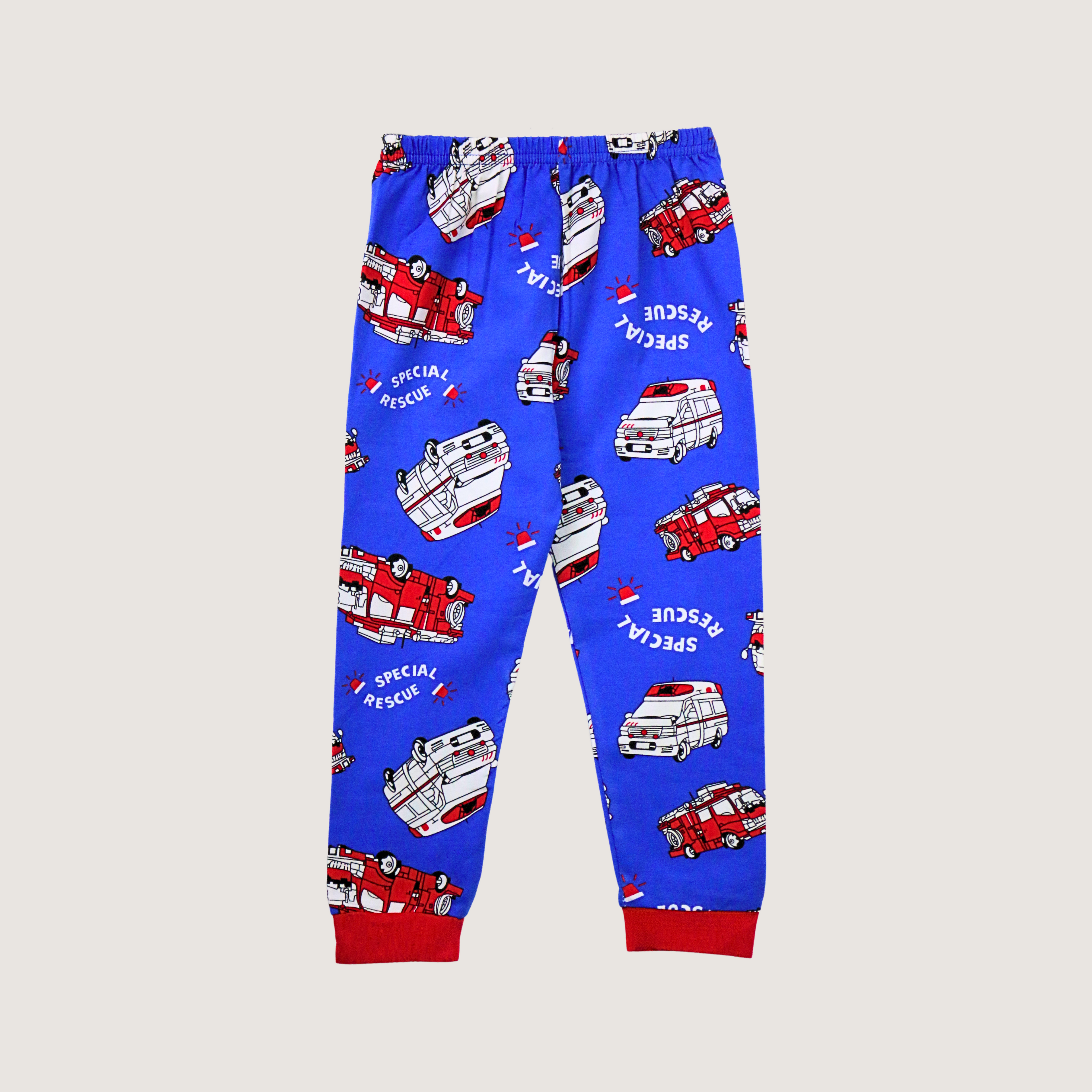 Blue children's pants with fire truck pattern on a beige background