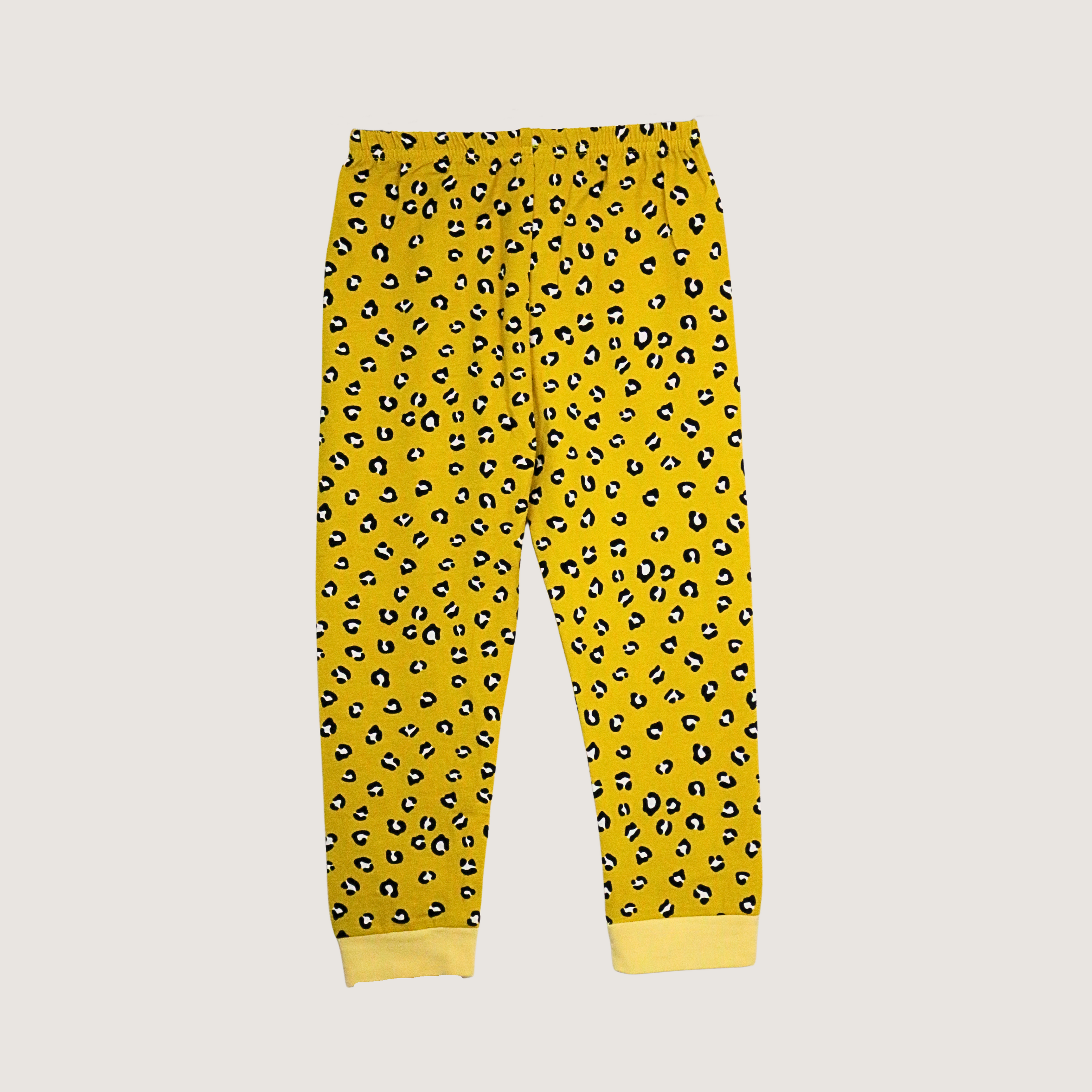 Yellow pajama pants with black leopard print pattern on a light gray background
