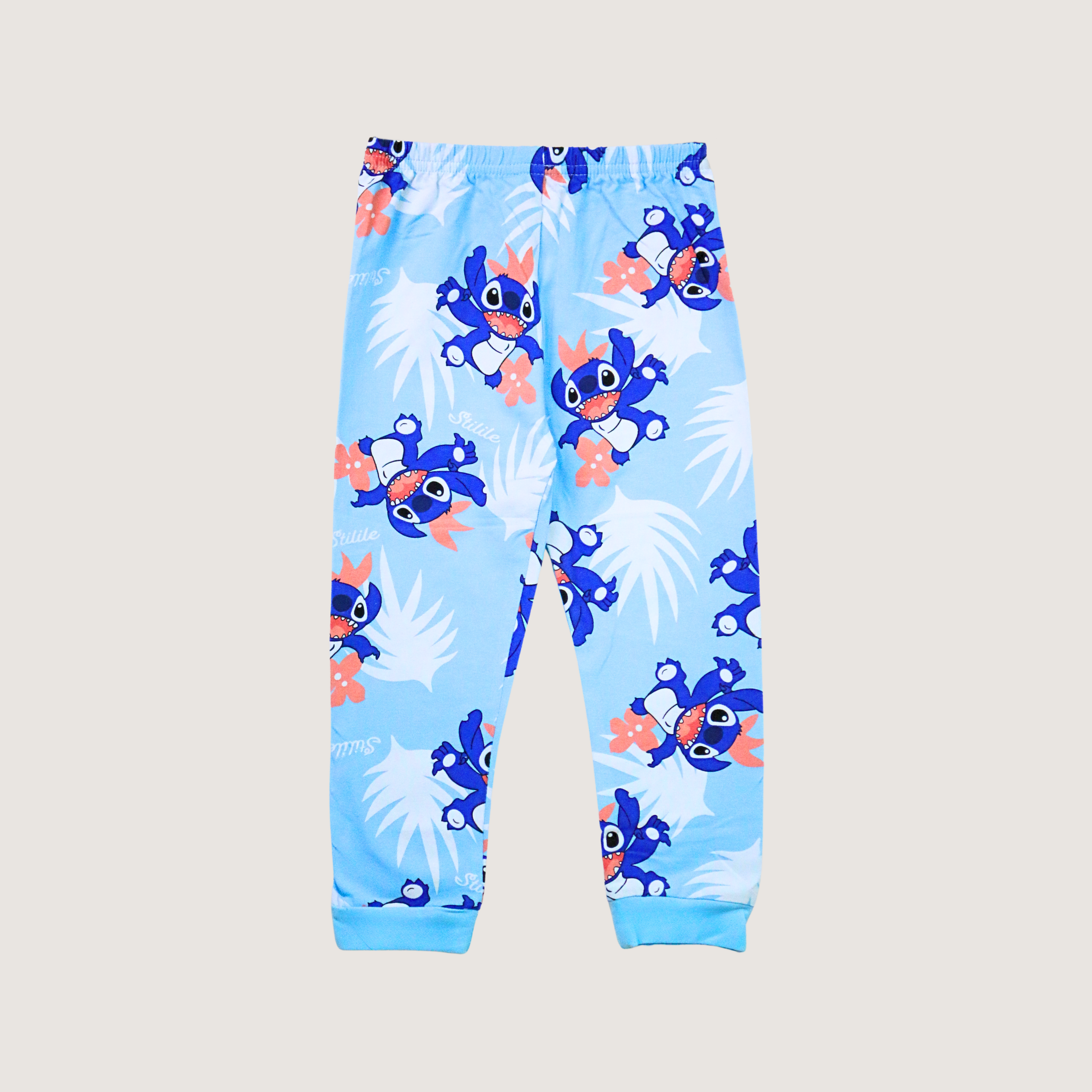 Blue children's pants with cartoon character pattern on a light gray background