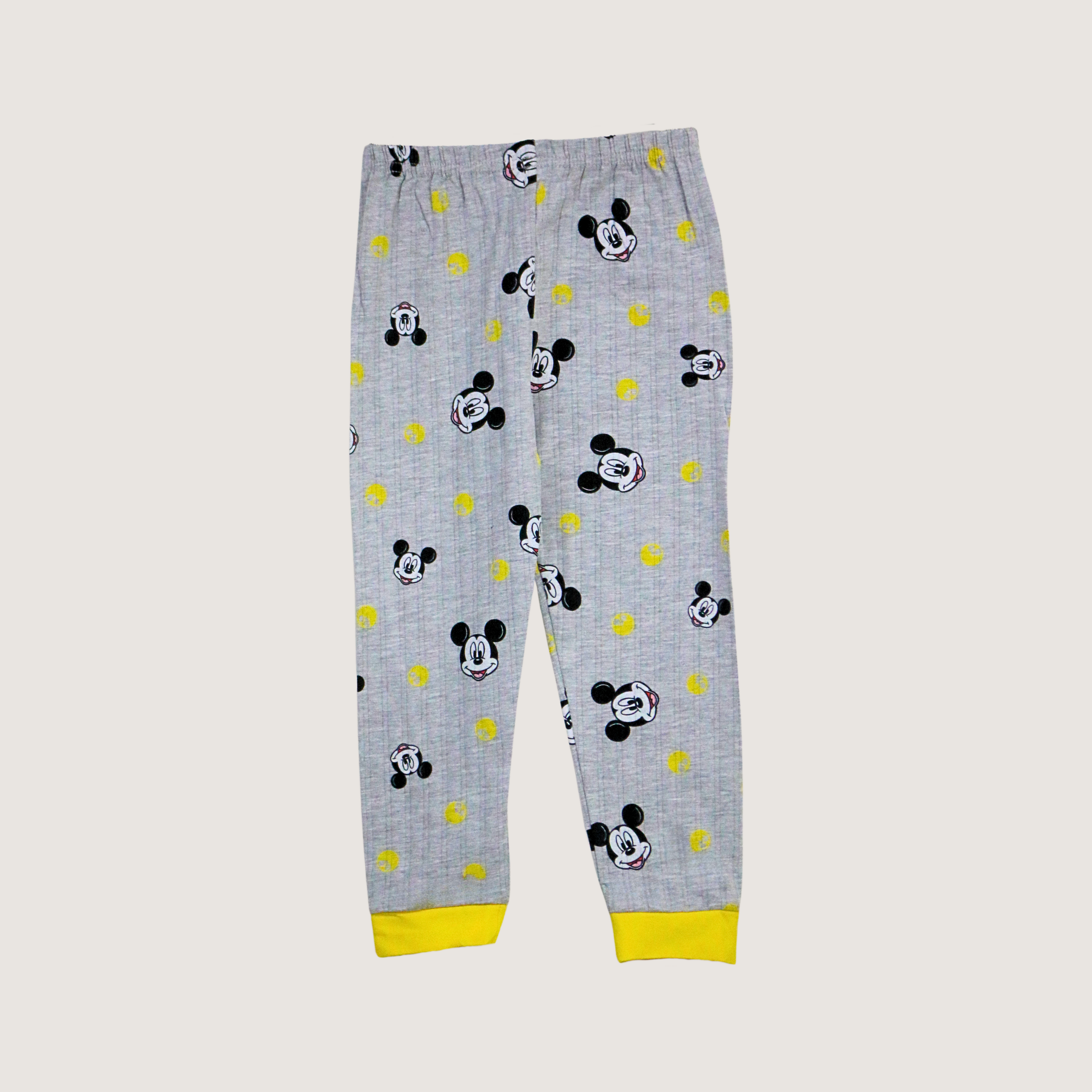 Gray pajama pants with Mickey Mouse pattern and yellow accents on a light gray background