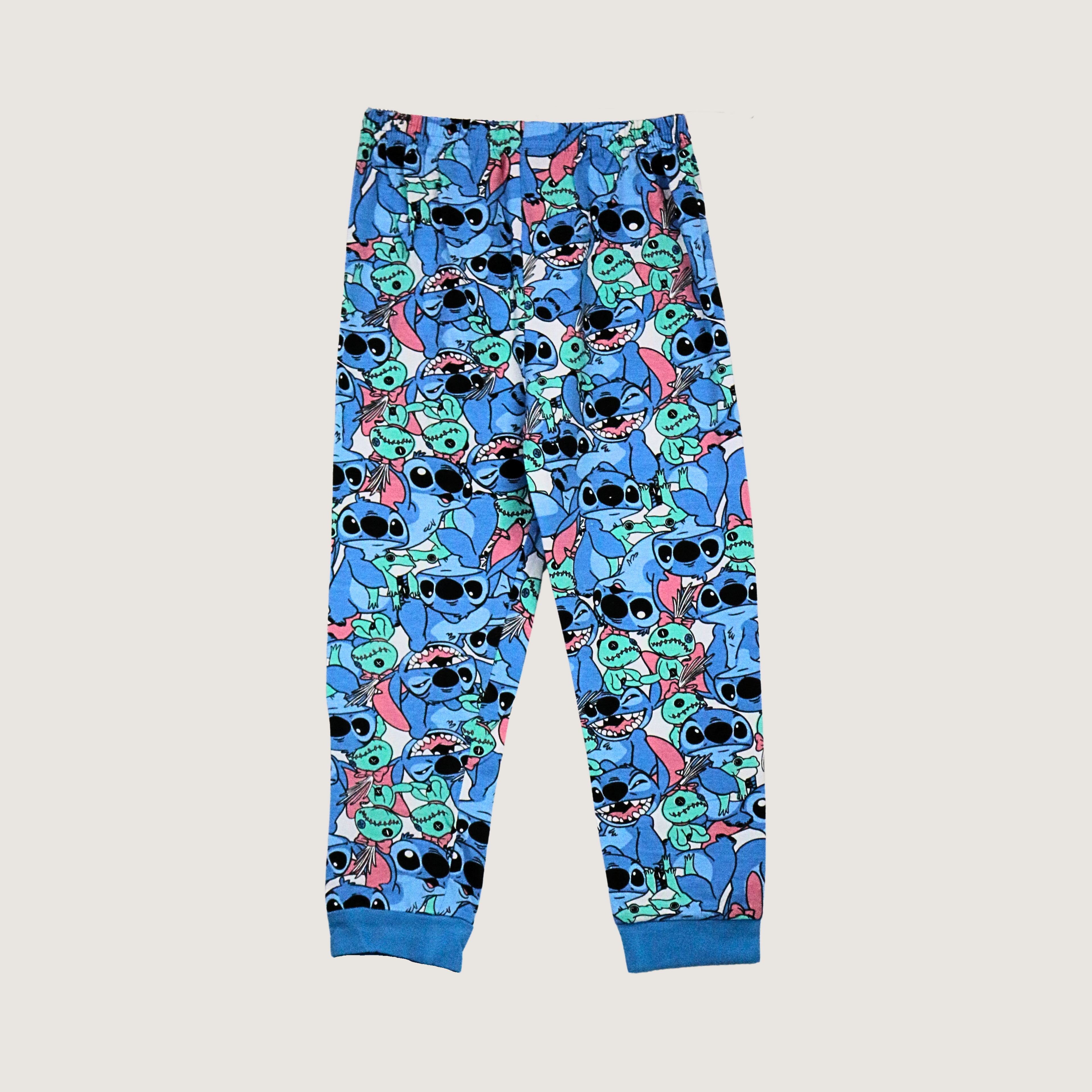 Pajama pants with a cartoon character pattern on a light gray background
