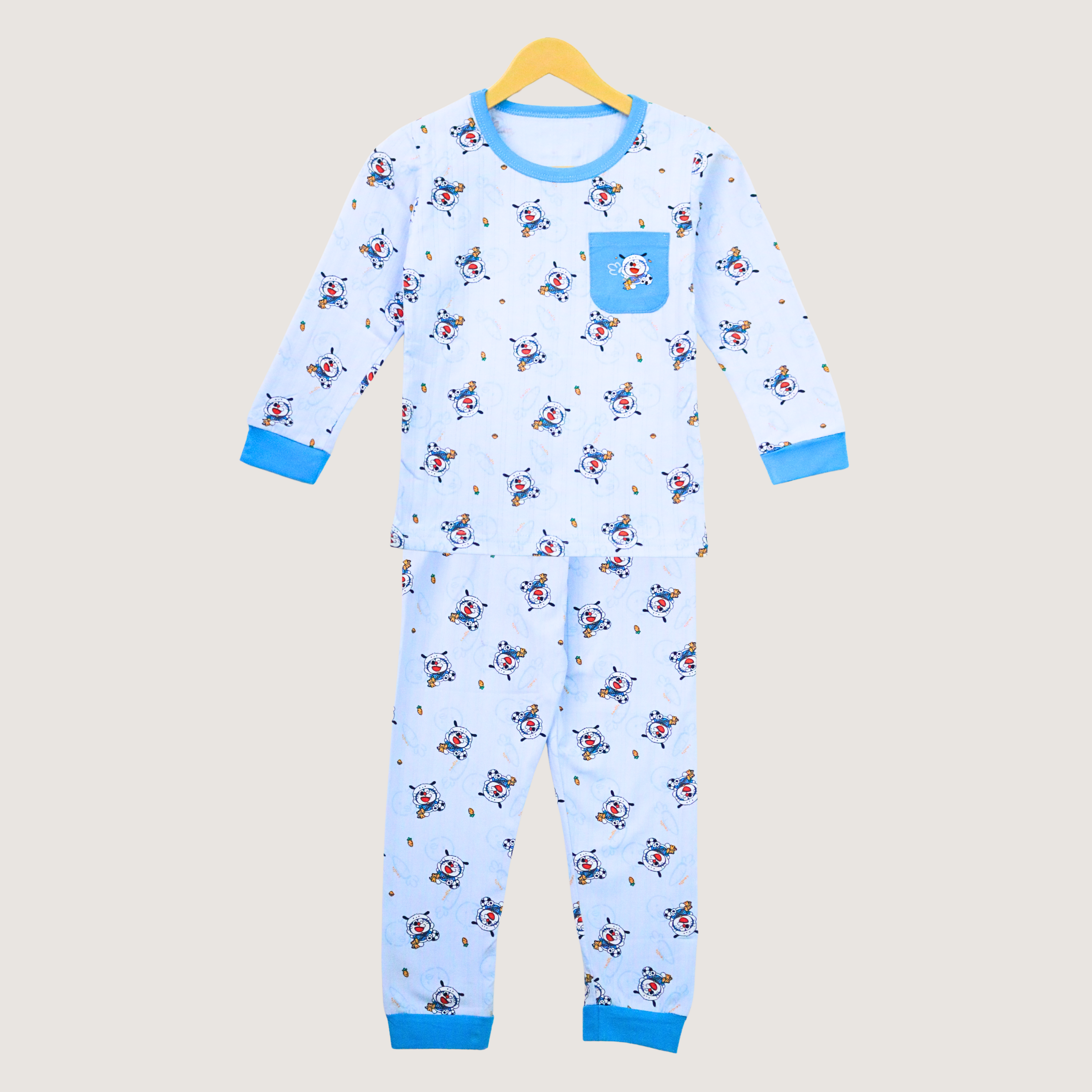 Children's pajama set with airplane pattern on a beige background