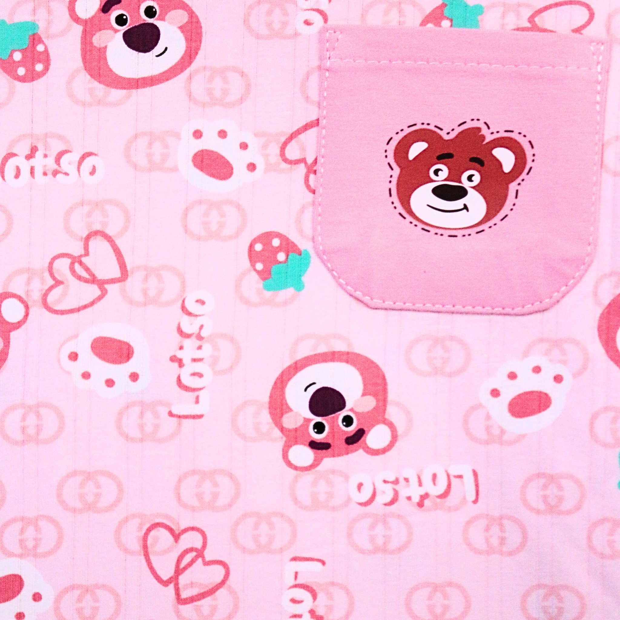 Pink fabric with cartoon bear designs and text