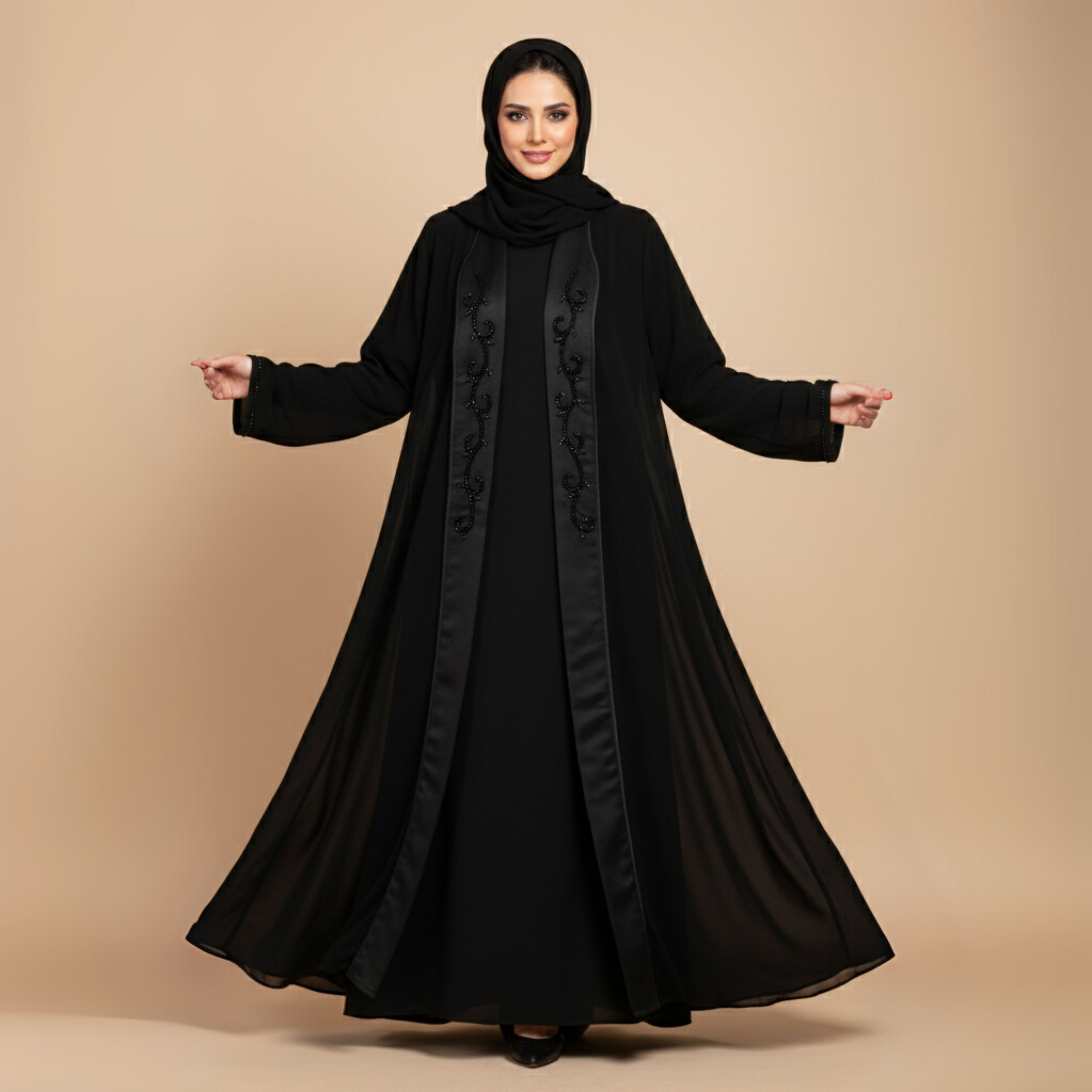 Woman wearing a black abaya with decorative patterns on a beige background