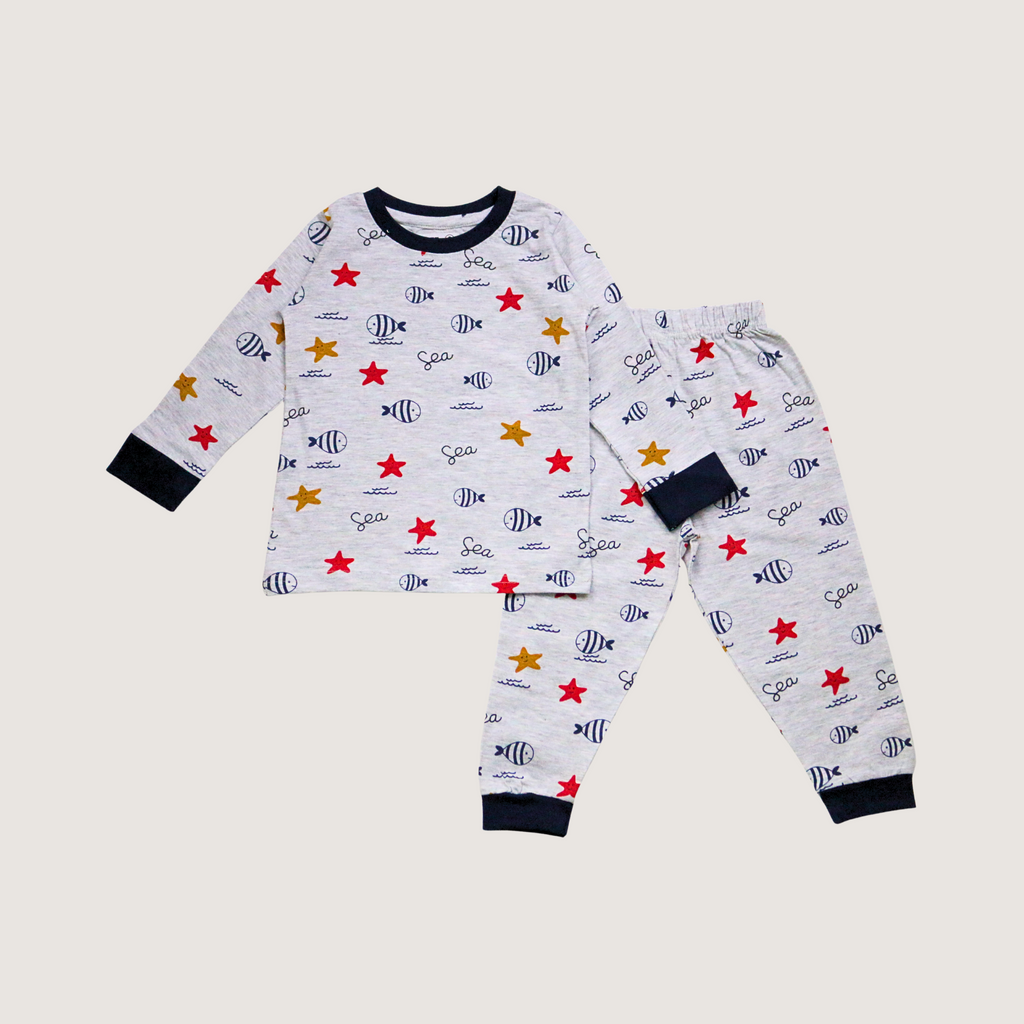 Children's pajama set with fish and star pattern on a light gray background