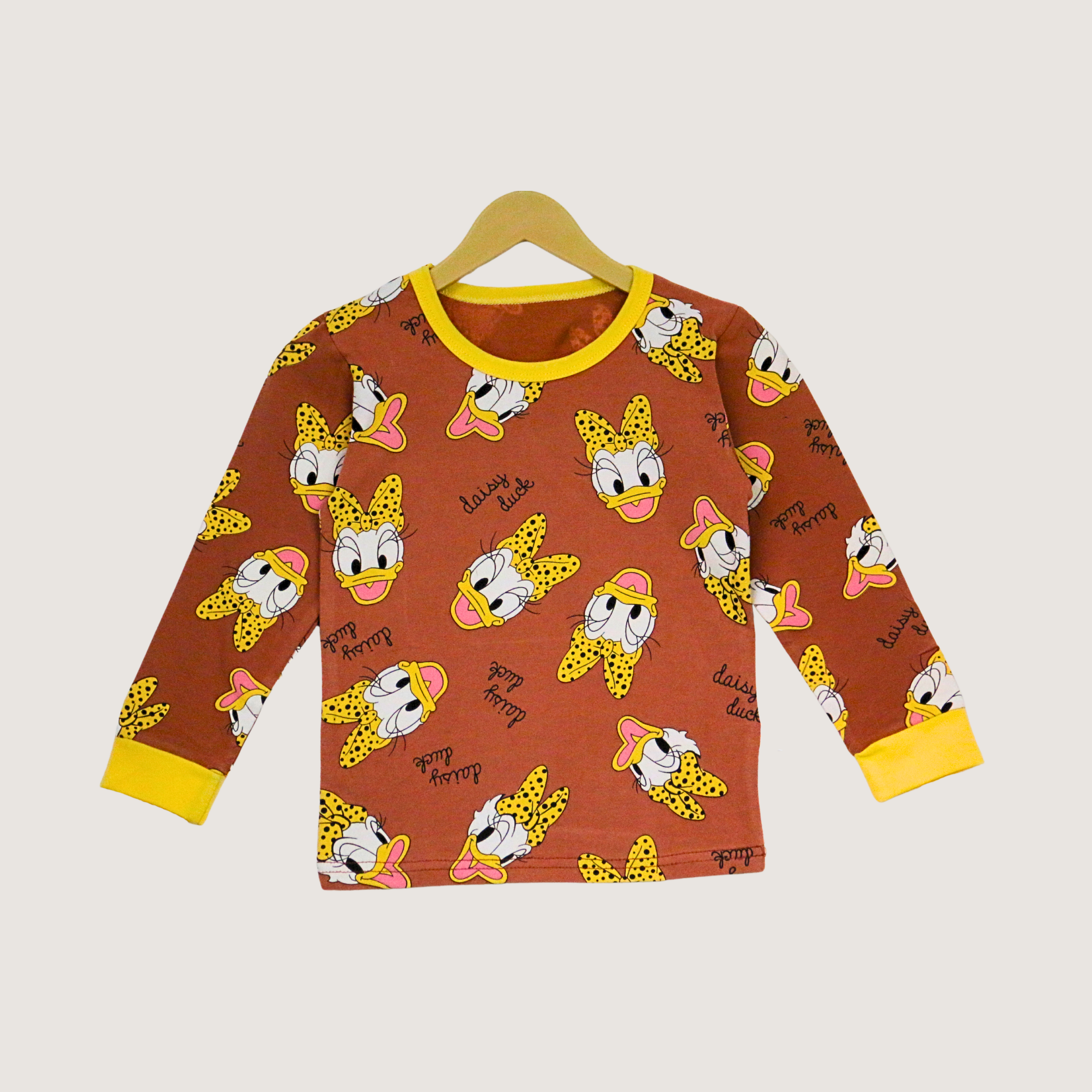 Children's long-sleeve shirt with cartoon character pattern on a hanger against a light background