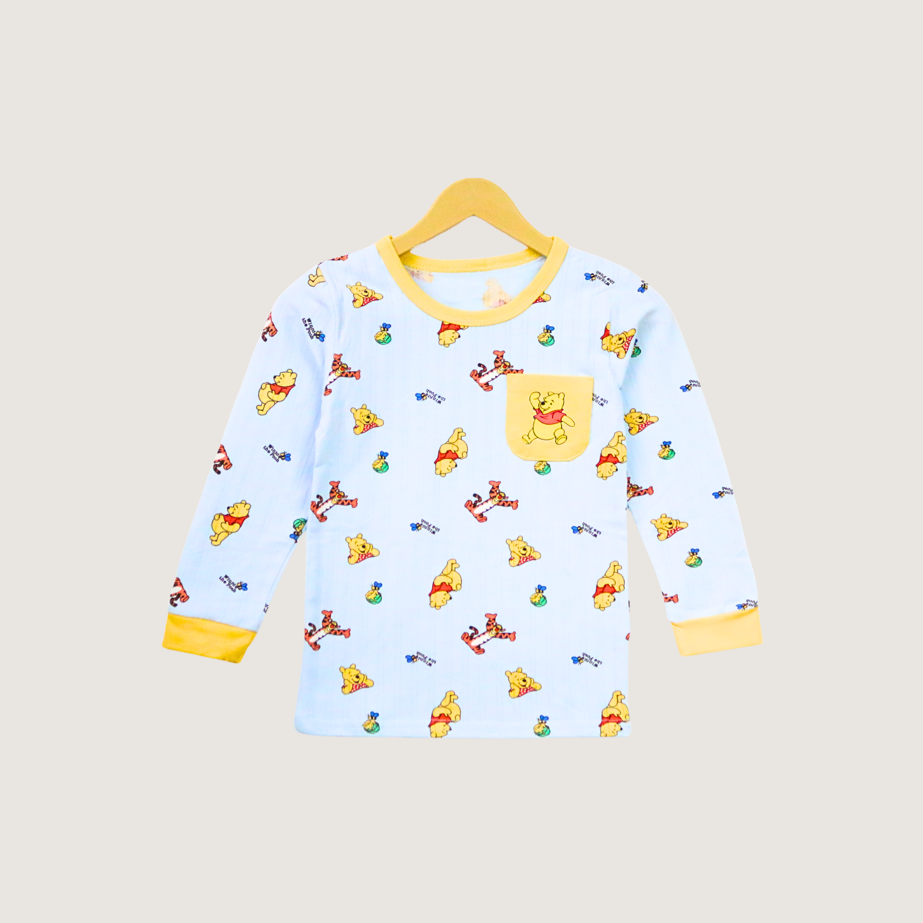 Children's long-sleeve shirt with cartoon character pattern on a beige background