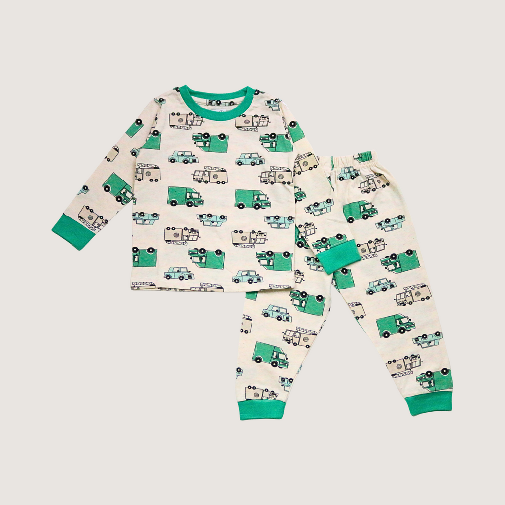 Children's pajama set with green and blue vehicle pattern on a beige background
