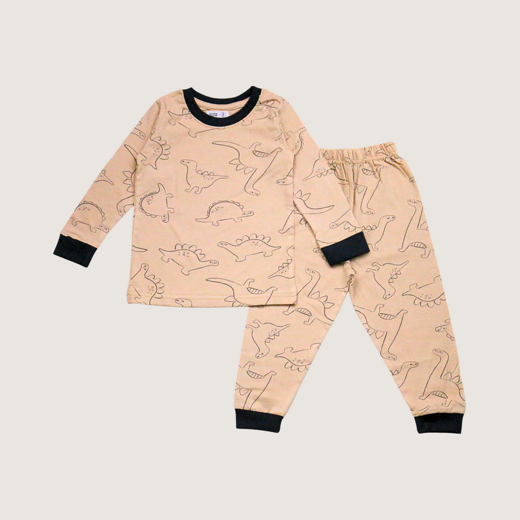 Children's pajama set with dinosaur pattern on a beige background