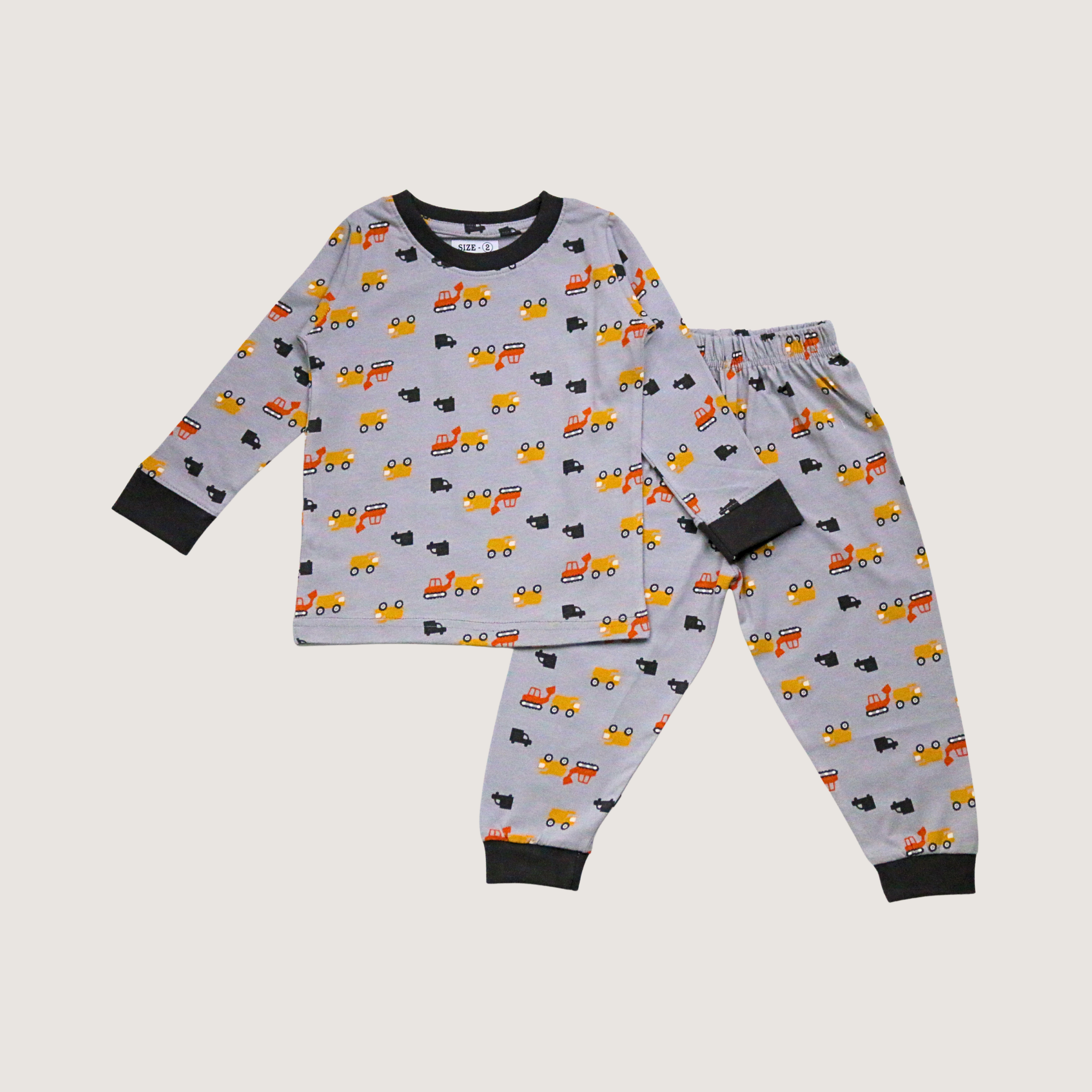 Children's pajama set with truck pattern on a light gray background