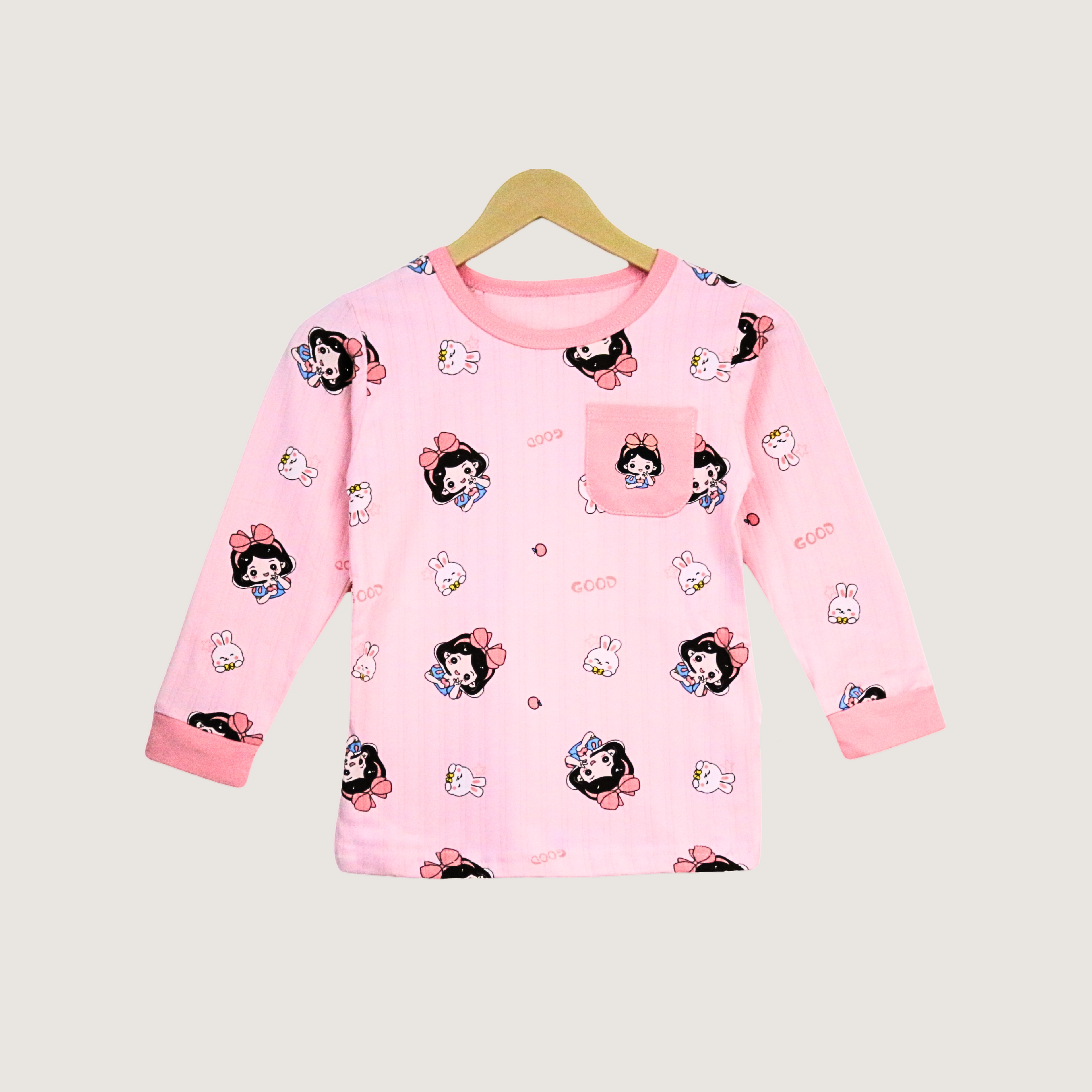 Pink children's pajama top with cartoon character print on a hanger against a light gray background