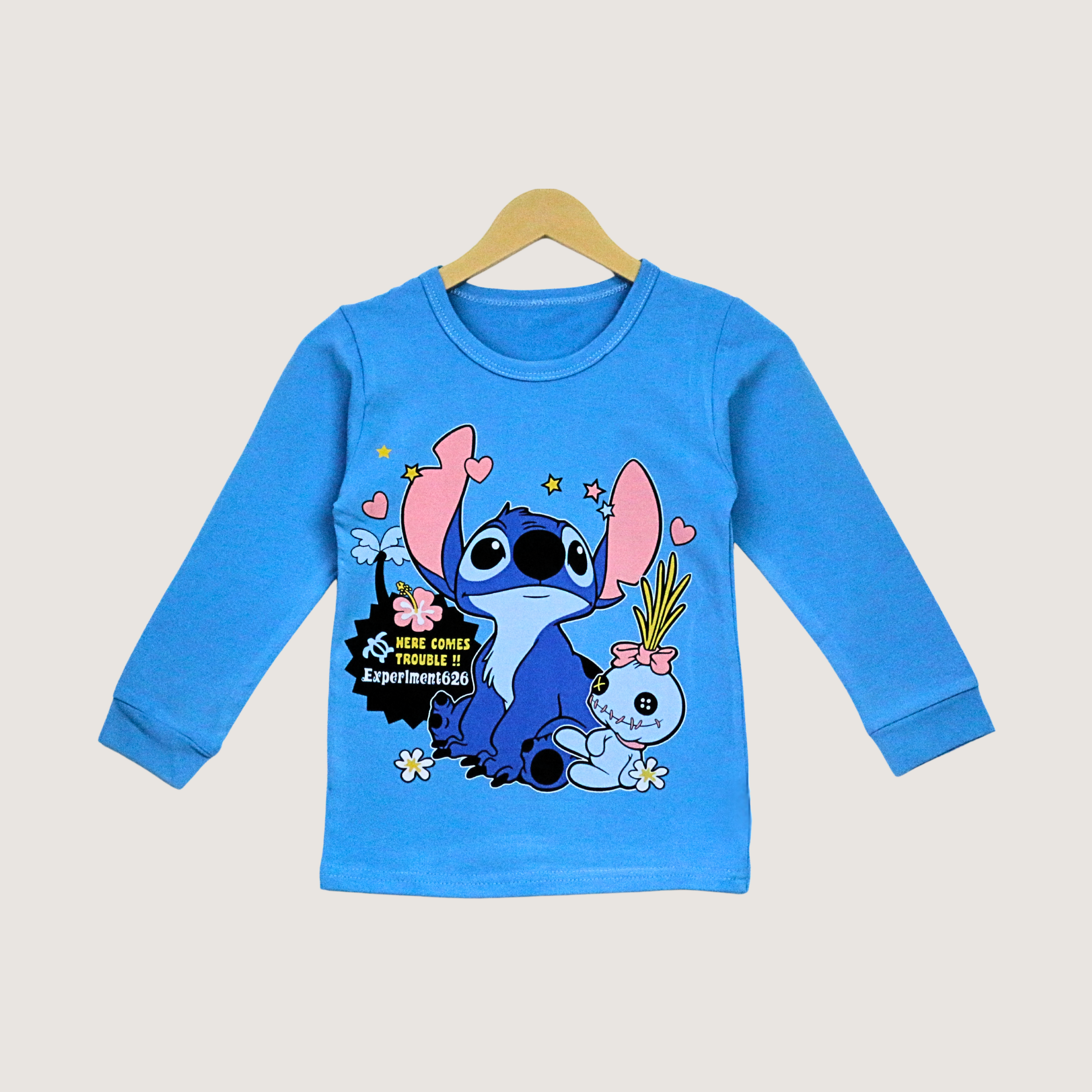 Blue long-sleeve shirt with cartoon character on a hanger against a light gray background