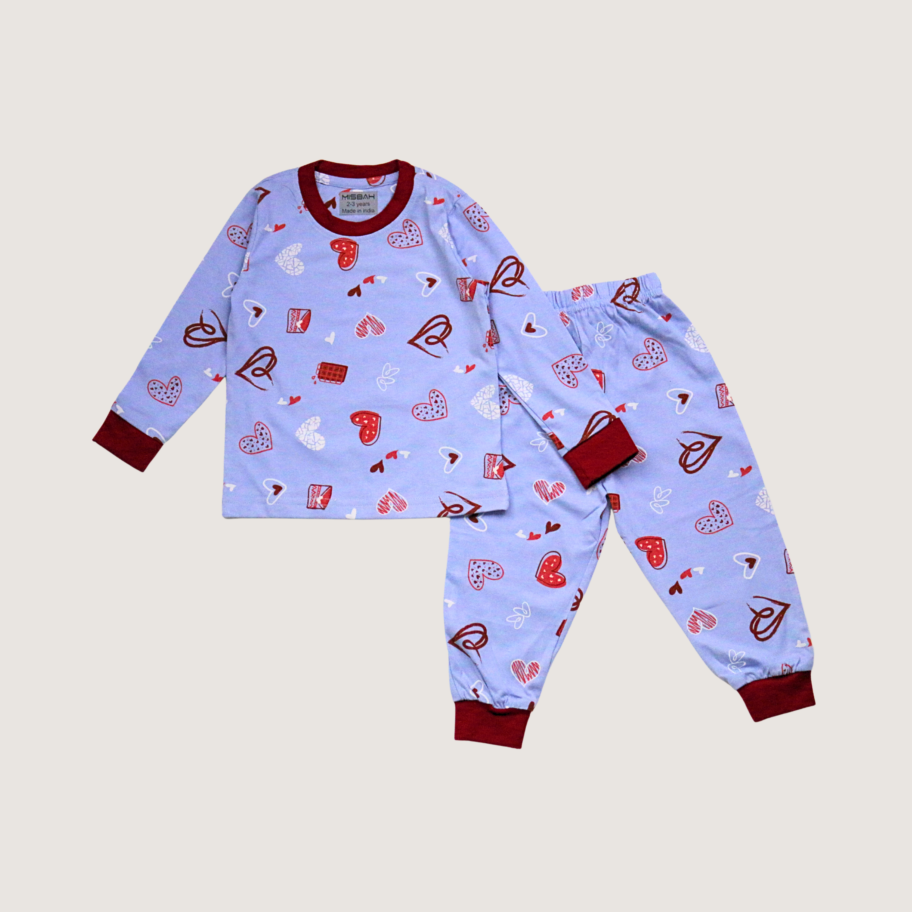 Children's pajama set with heart pattern on a light blue background