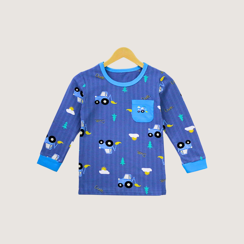 Blue children's pajama top with truck pattern on a beige background