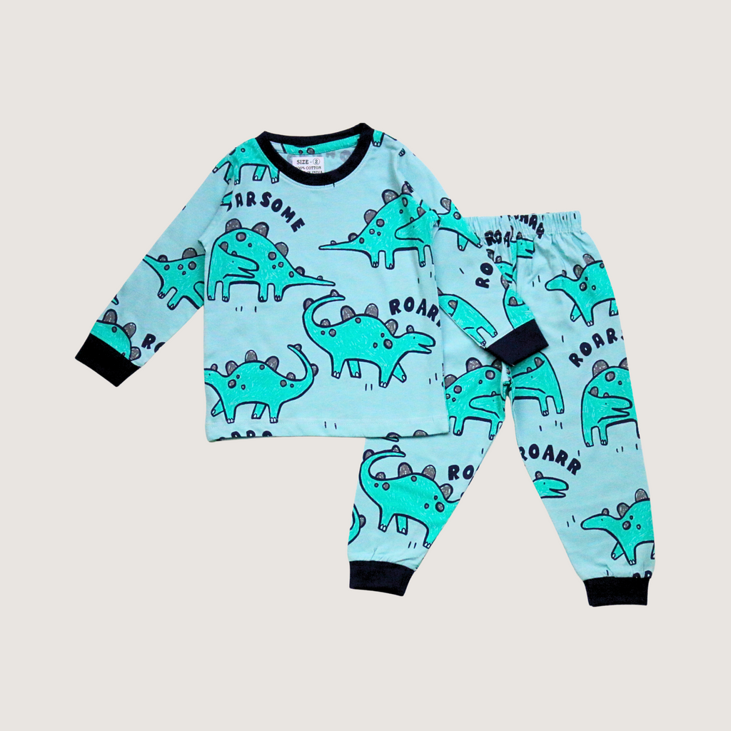 Children's pajama set with dinosaur pattern on a light gray background