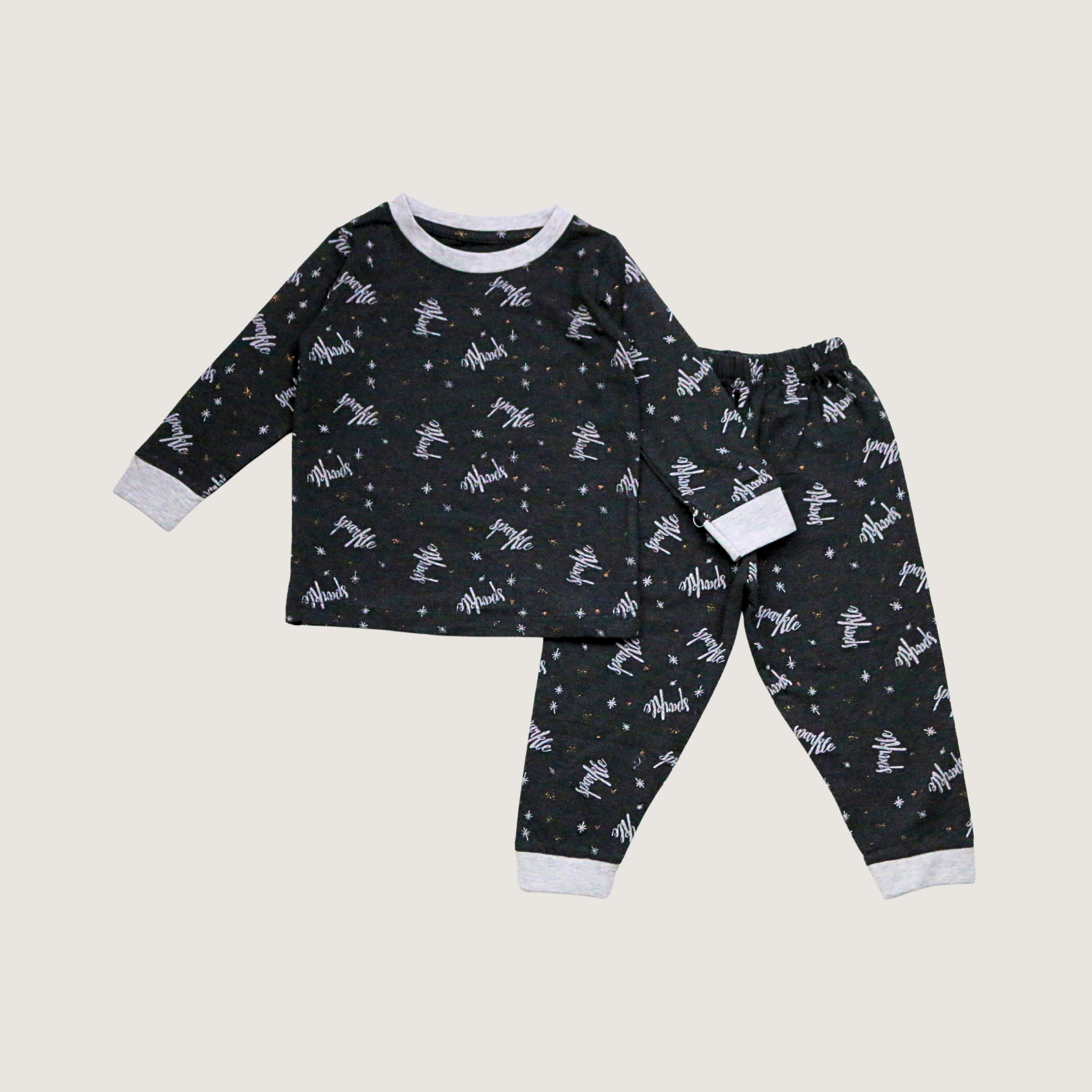 Children's pajama set with space-themed design on a light gray background