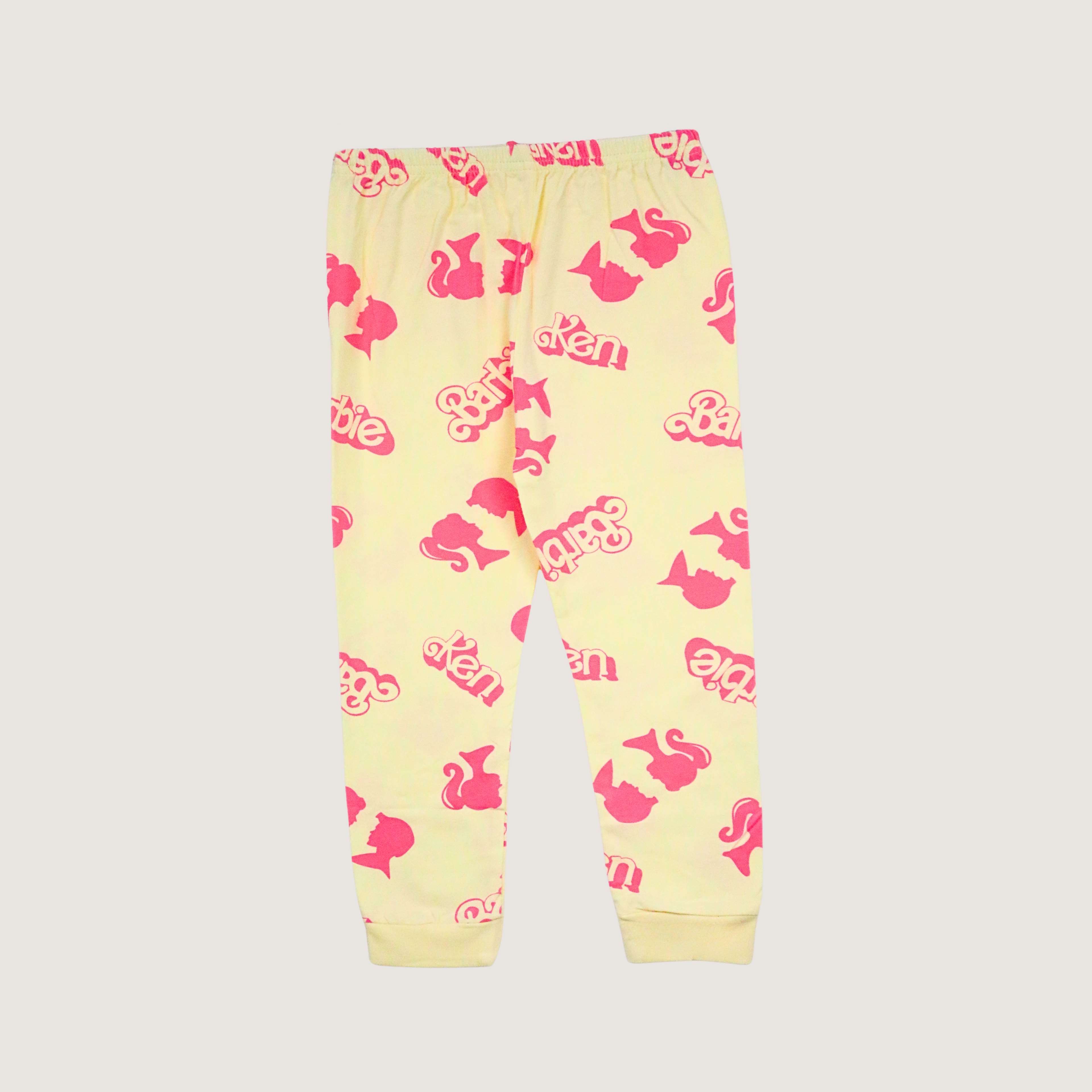 Yellow children's pants with pink patterns on a light gray background