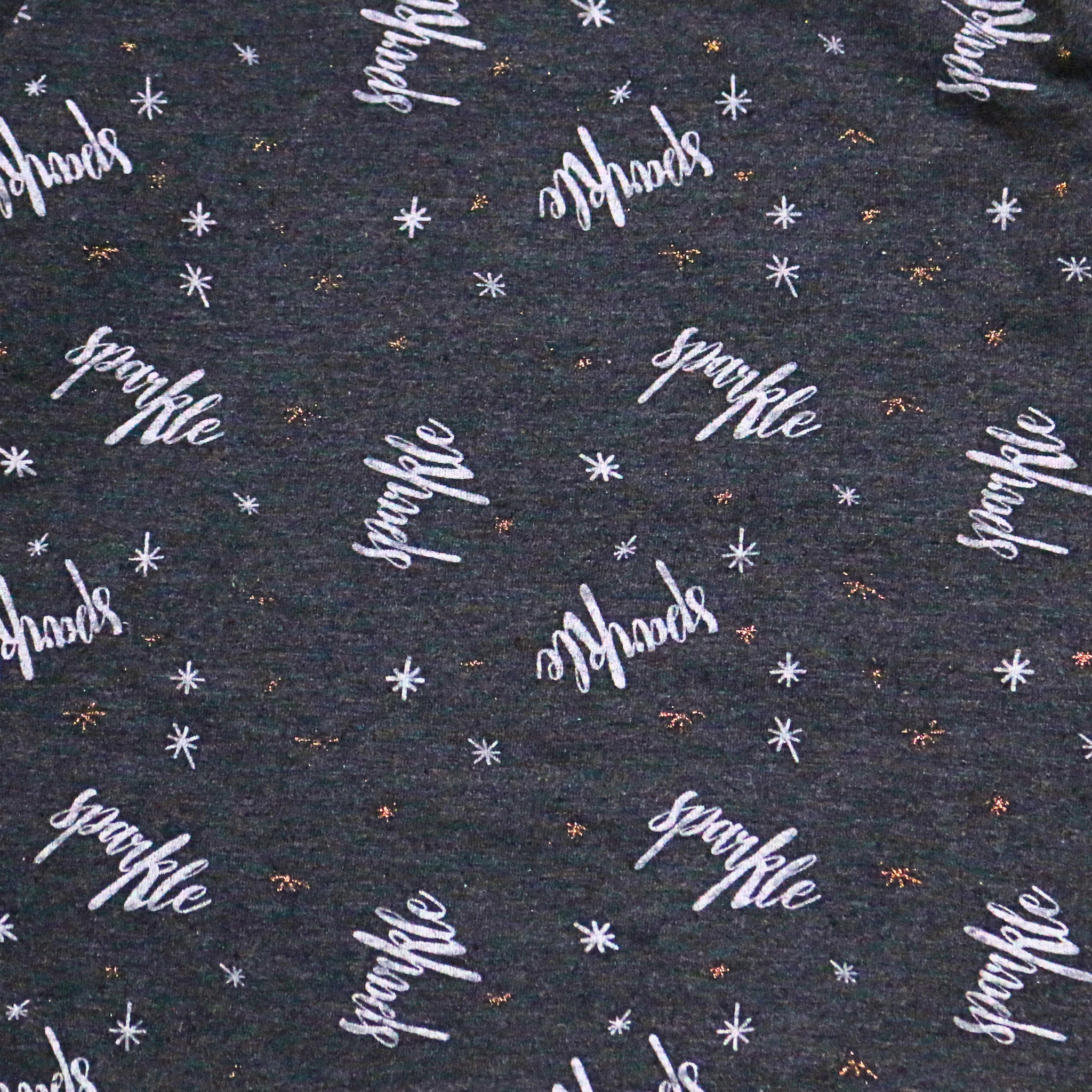 Patterned fabric with 'sparkle' text and star designs on a dark background