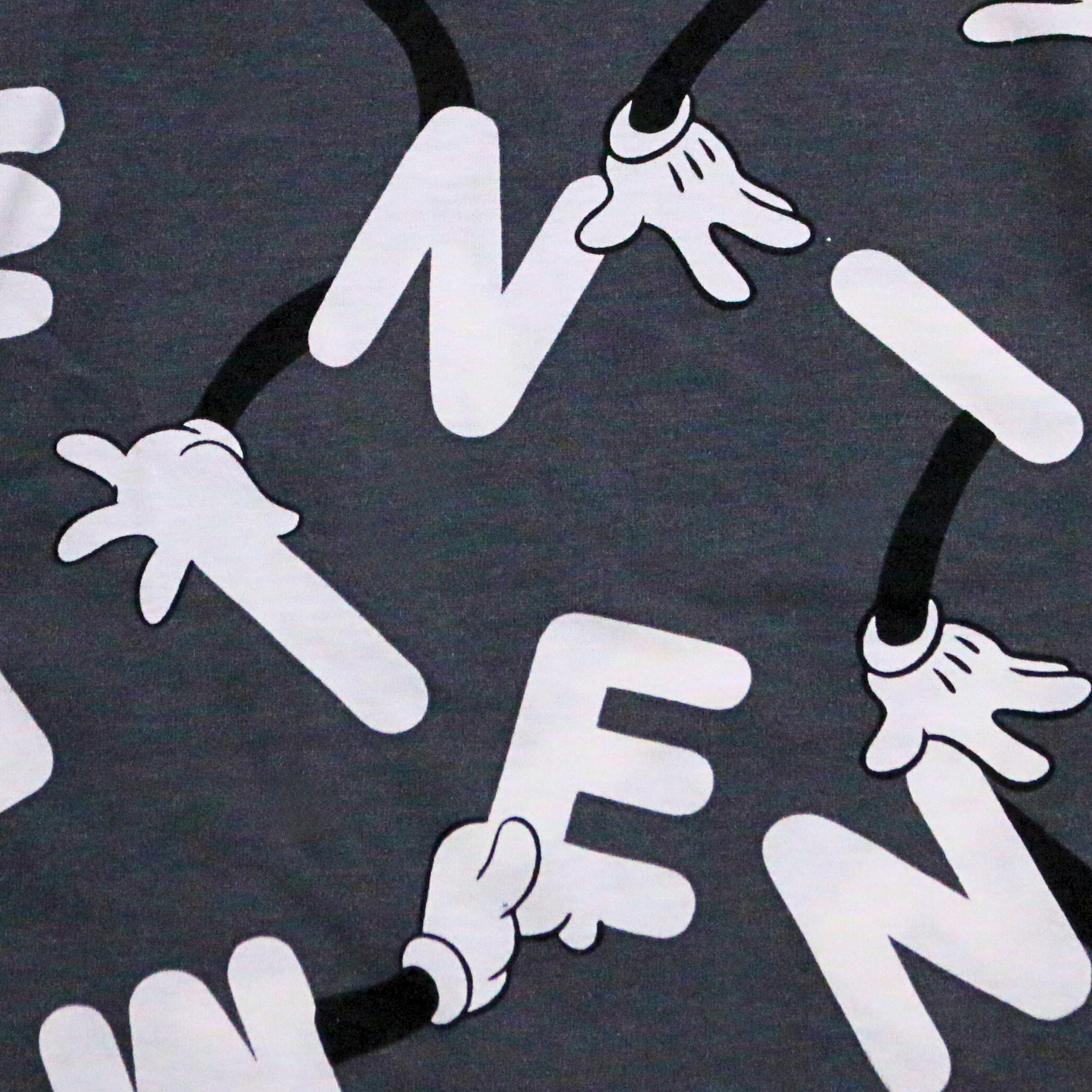 Black shirt with white graphic of hands holding letters spelling 'MEN' on a dark background