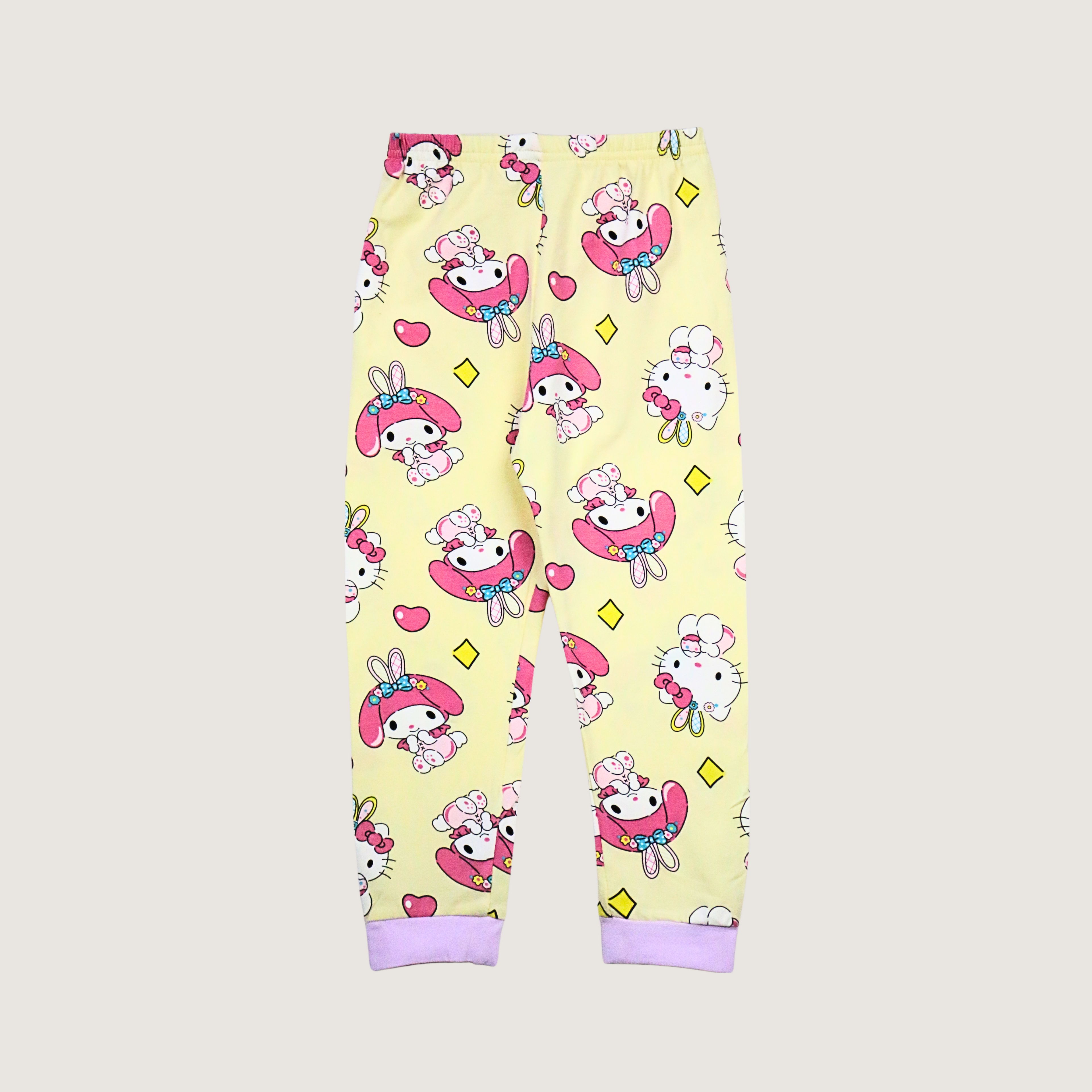 Yellow pajama pants with cartoon character pattern on a white background