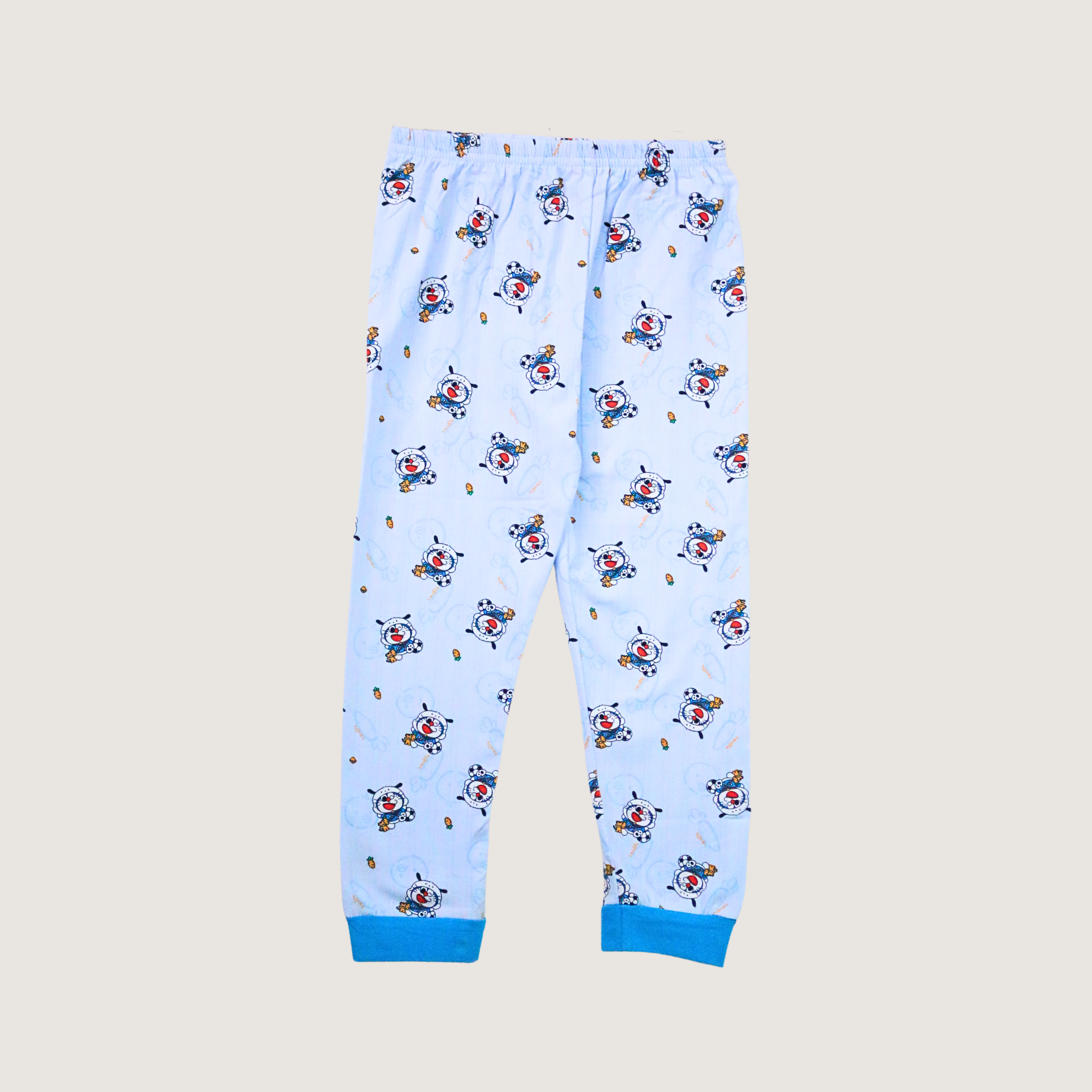 Children's pajama pants with cartoon character pattern on a beige background