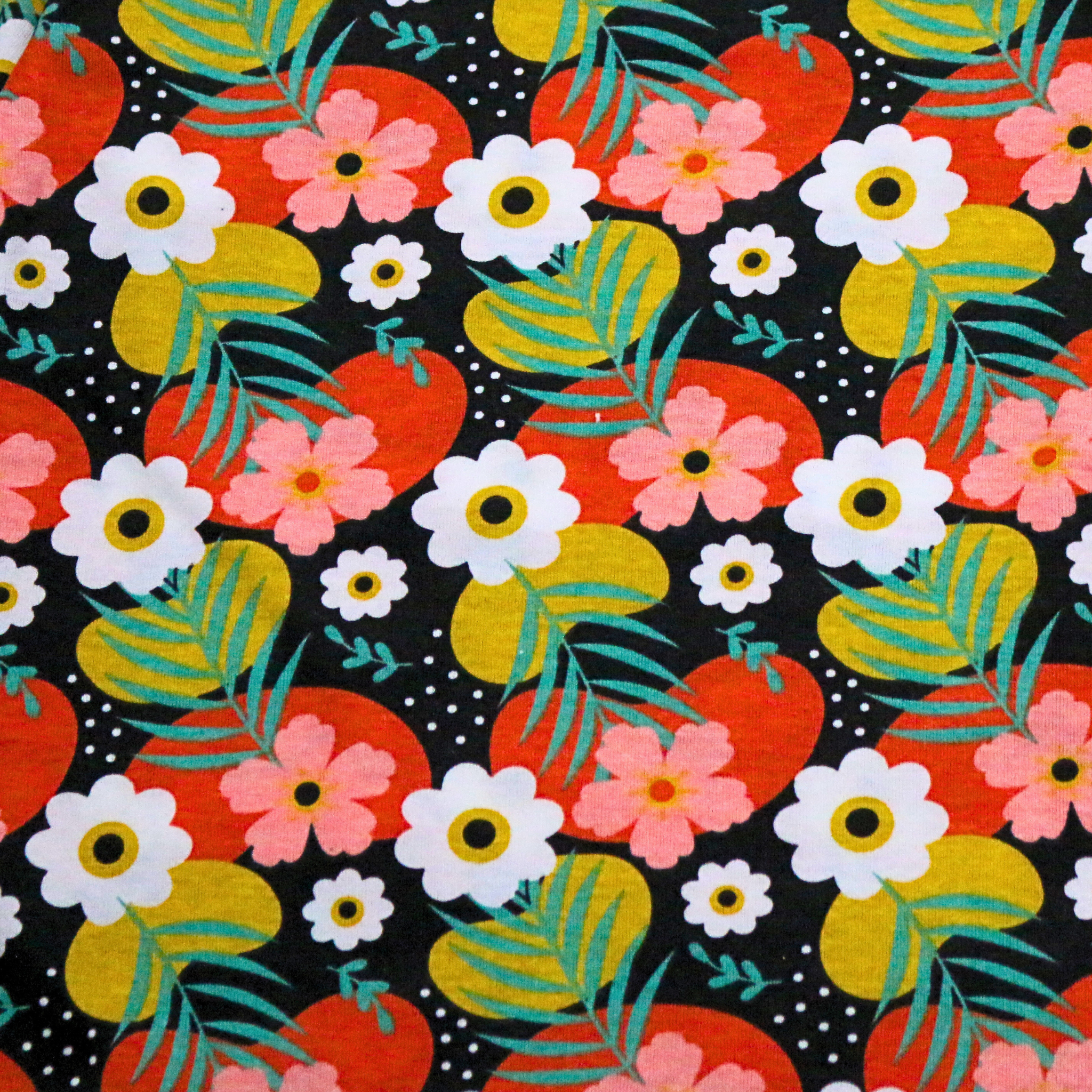 Colorful floral and fruit pattern on a black background