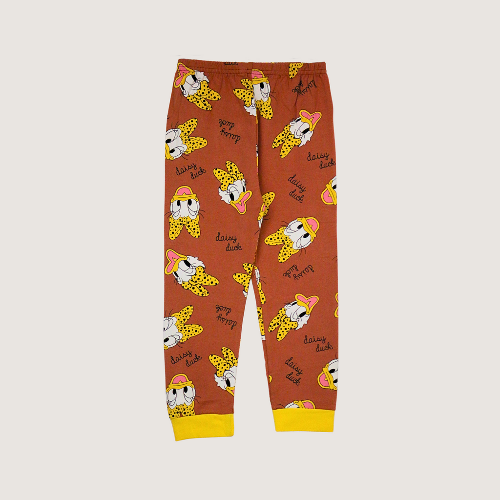 Children's pajama pants with cartoon character pattern on a beige background