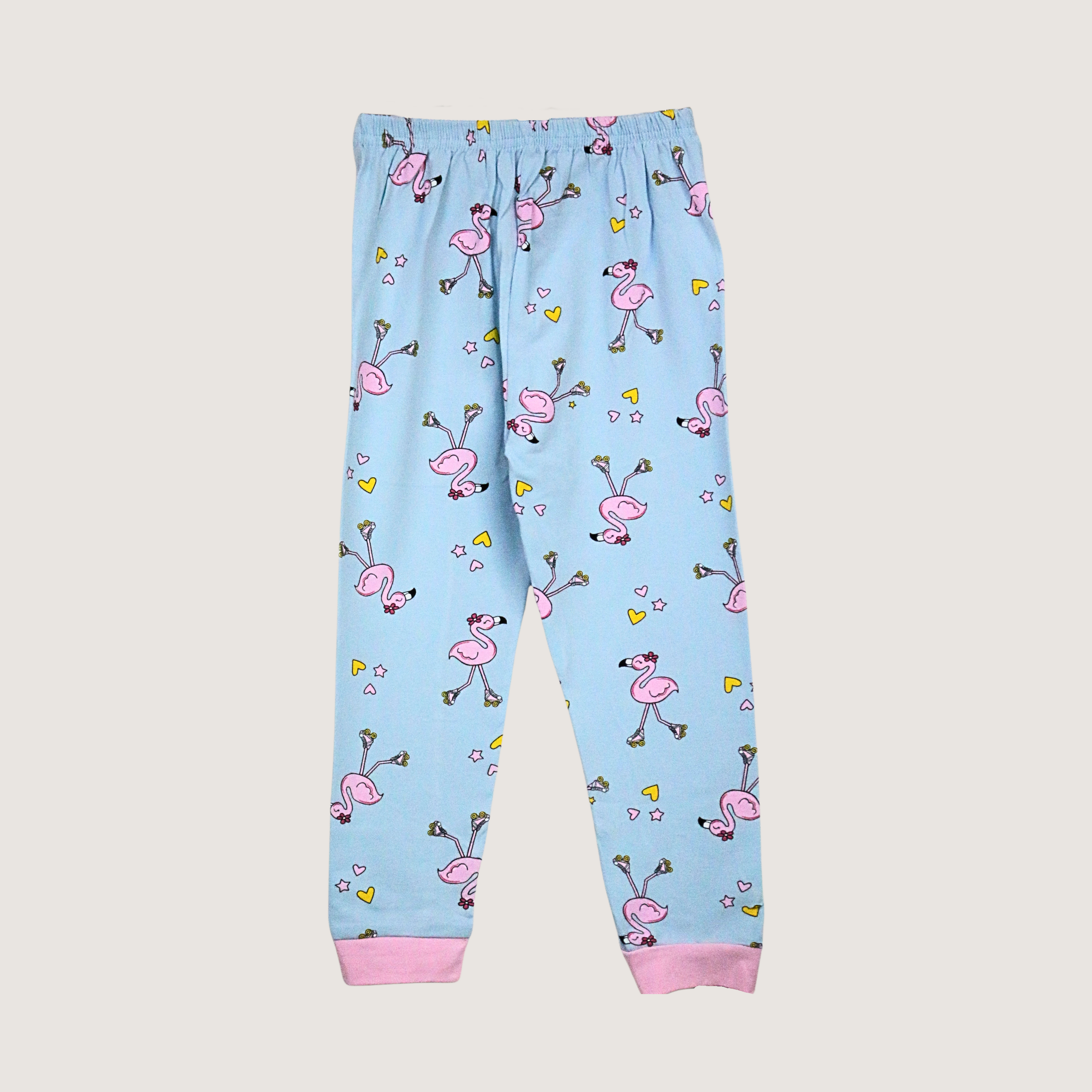 Light blue children's pajama pants with pink flamingo pattern on a light gray background