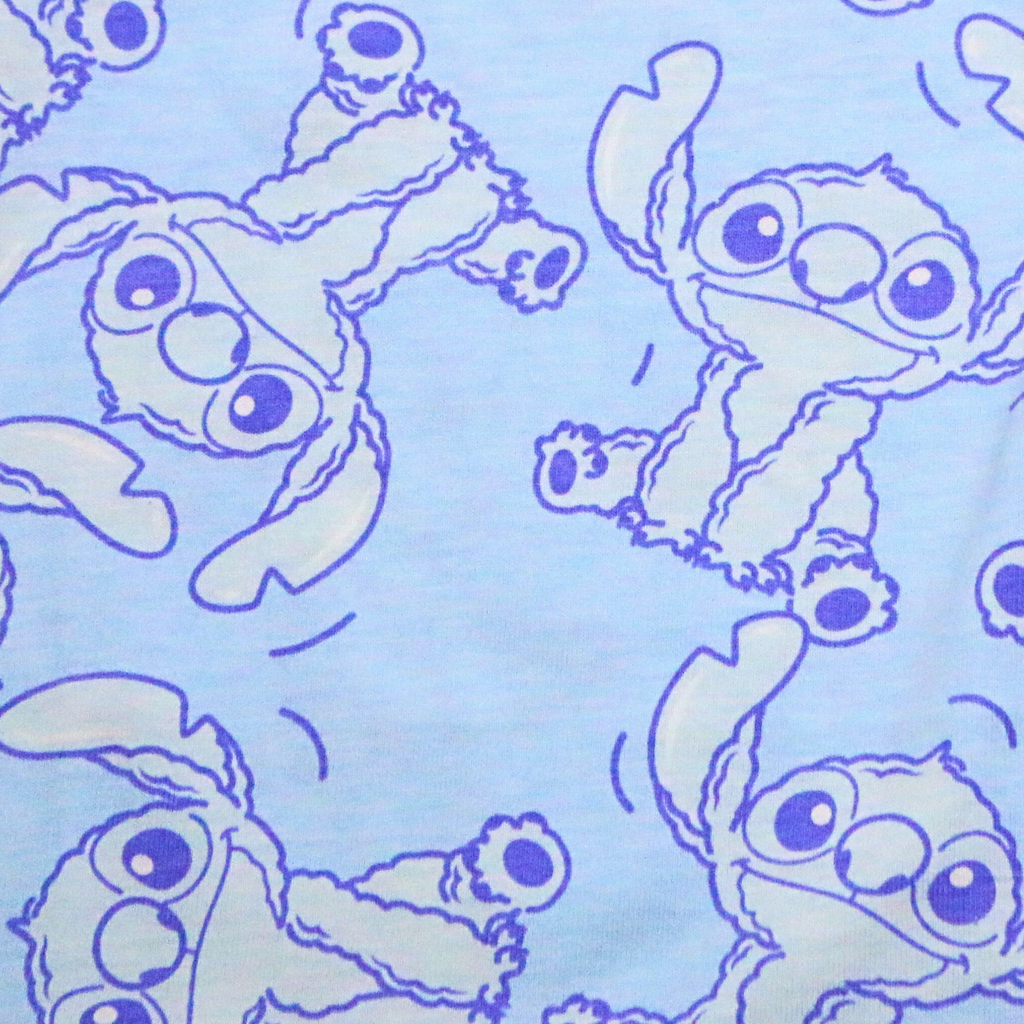Pattern of cartoon characters with large eyes on a light blue background
