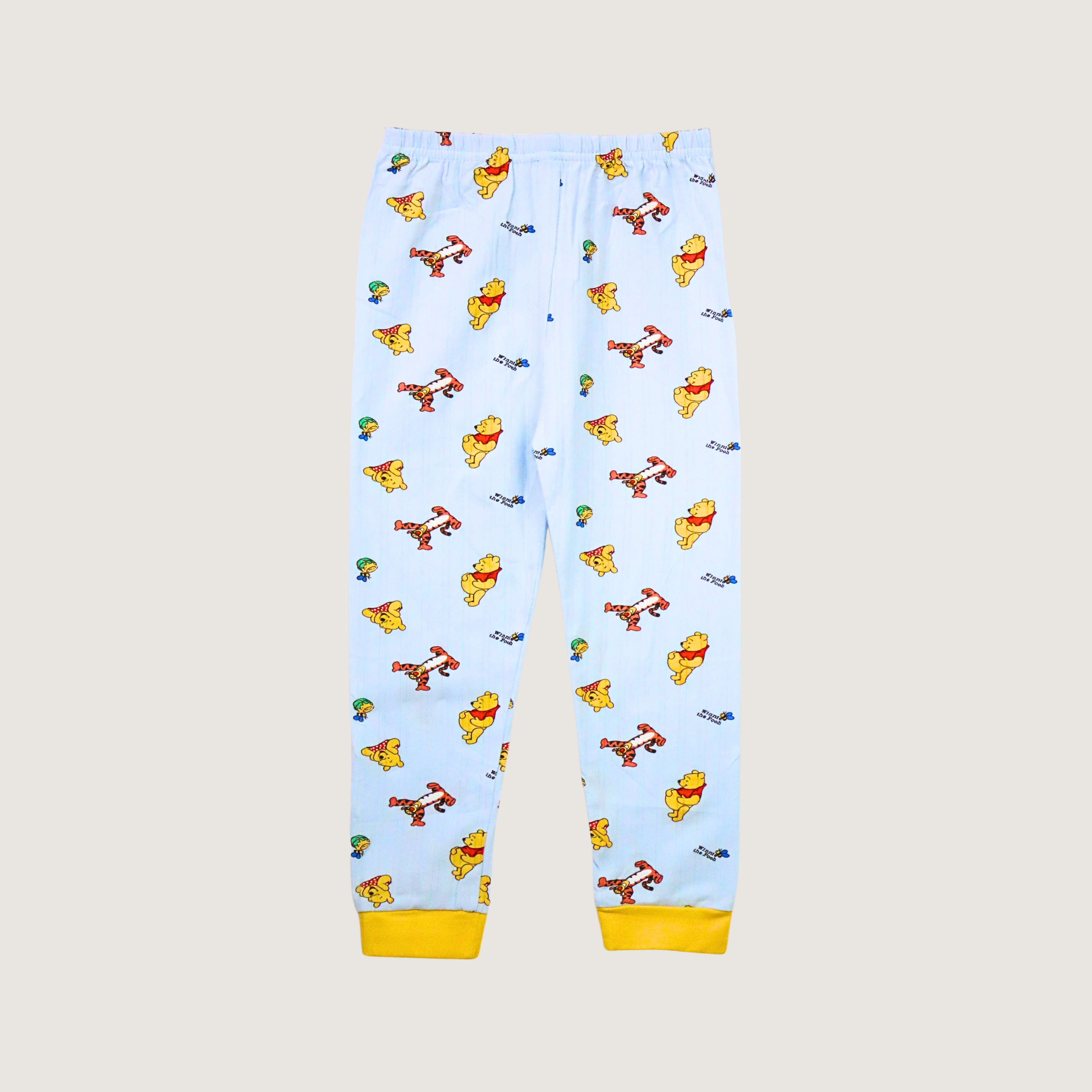 Children's pajama pants with cartoon character pattern on a light blue background