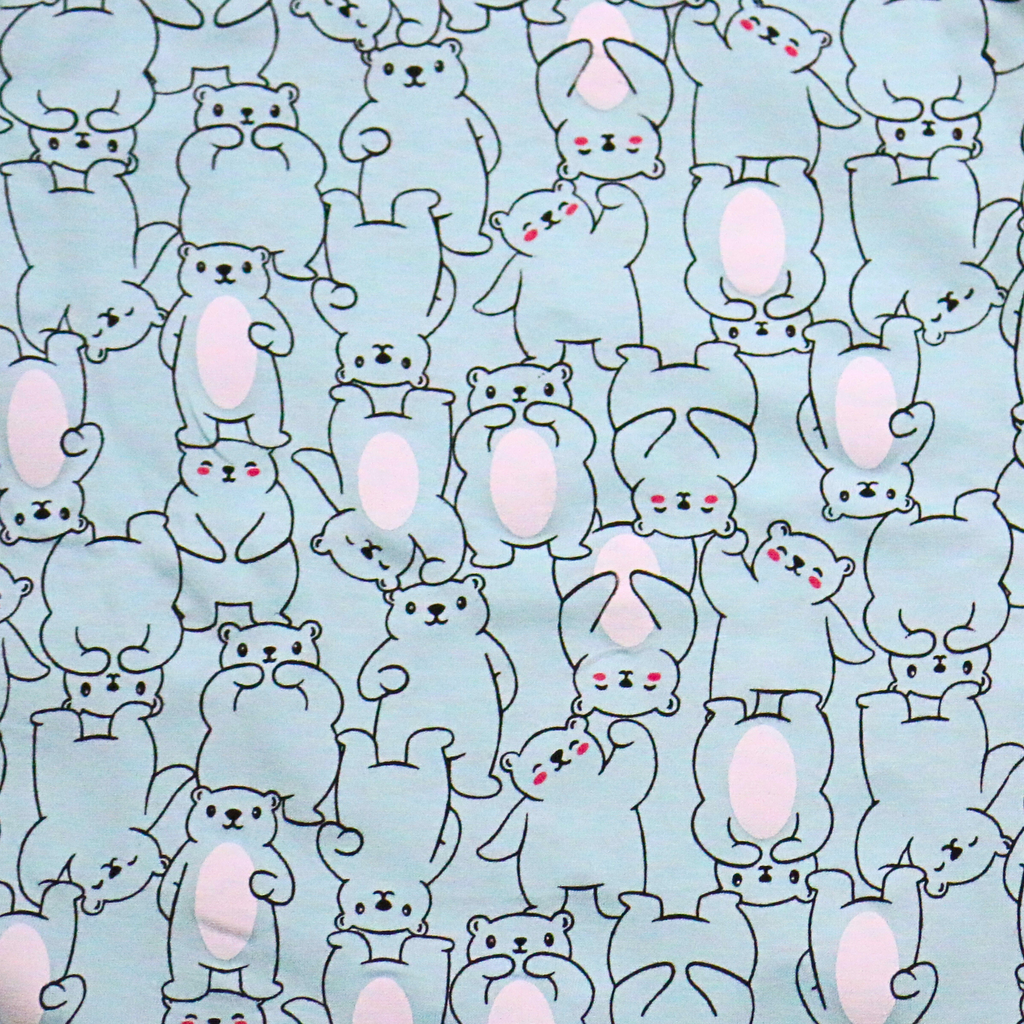 Pattern of cartoon bunnies with pink cheeks on a light blue background