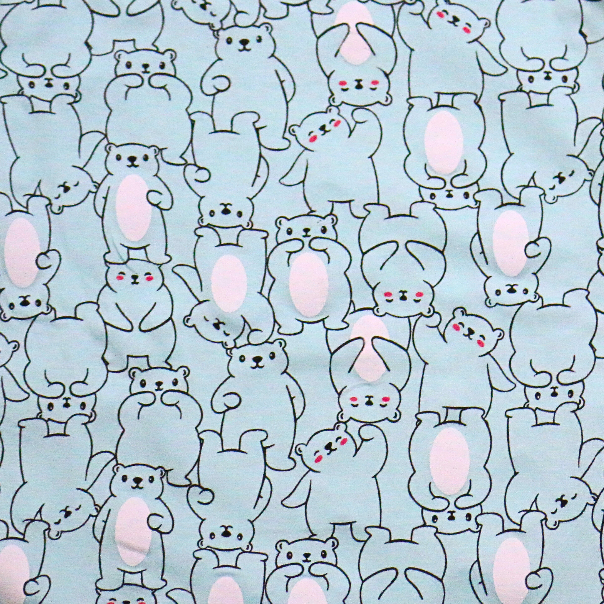 Pattern of cartoon bunnies with pink cheeks on a light blue background