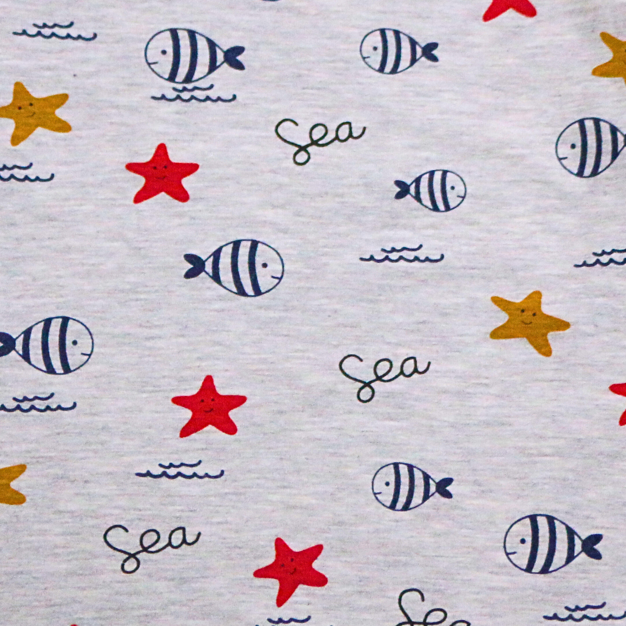 Fabric with sea-themed pattern including fish, stars, and 'Sea' text on a light gray background.