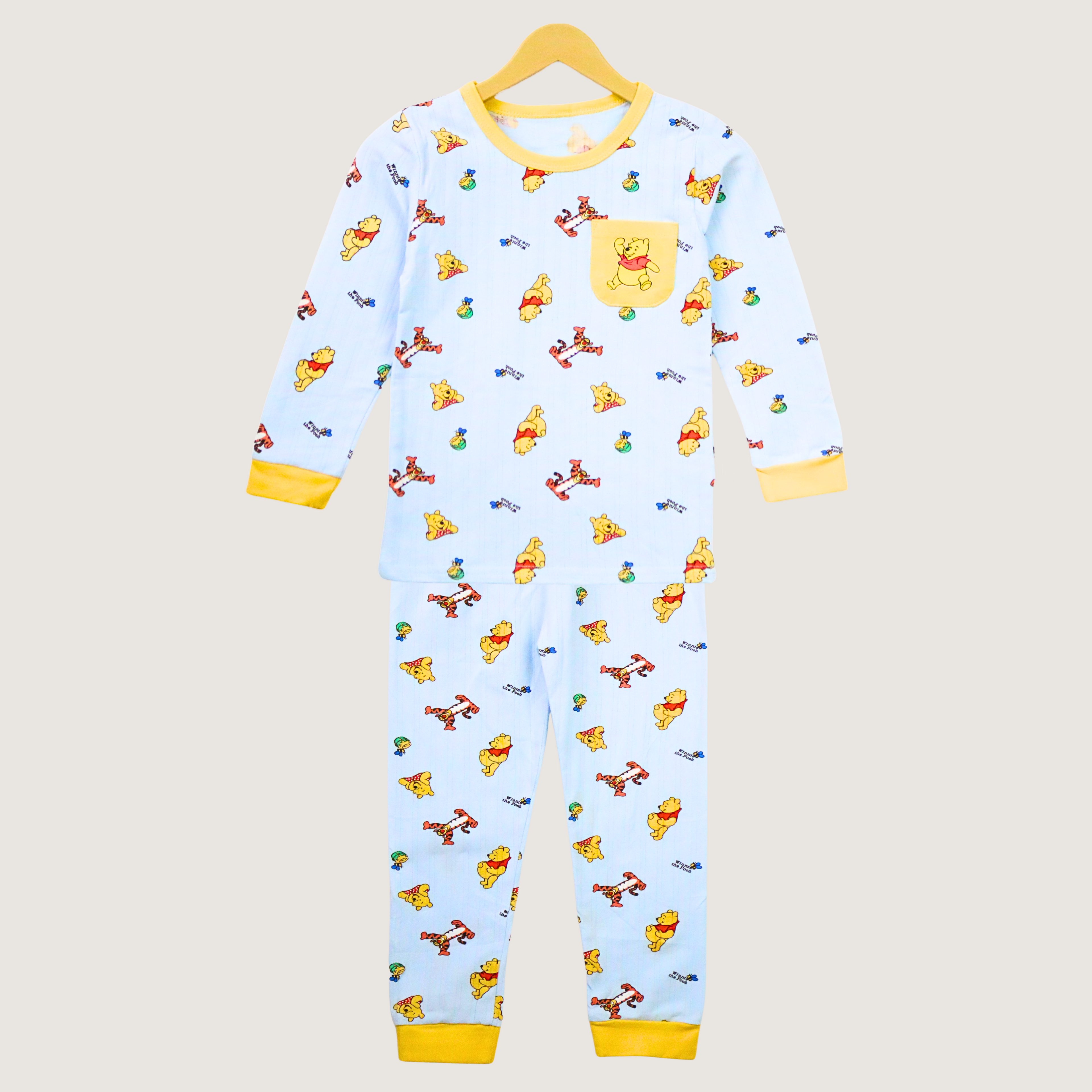 Children's onesie with cartoon character pattern on a beige background