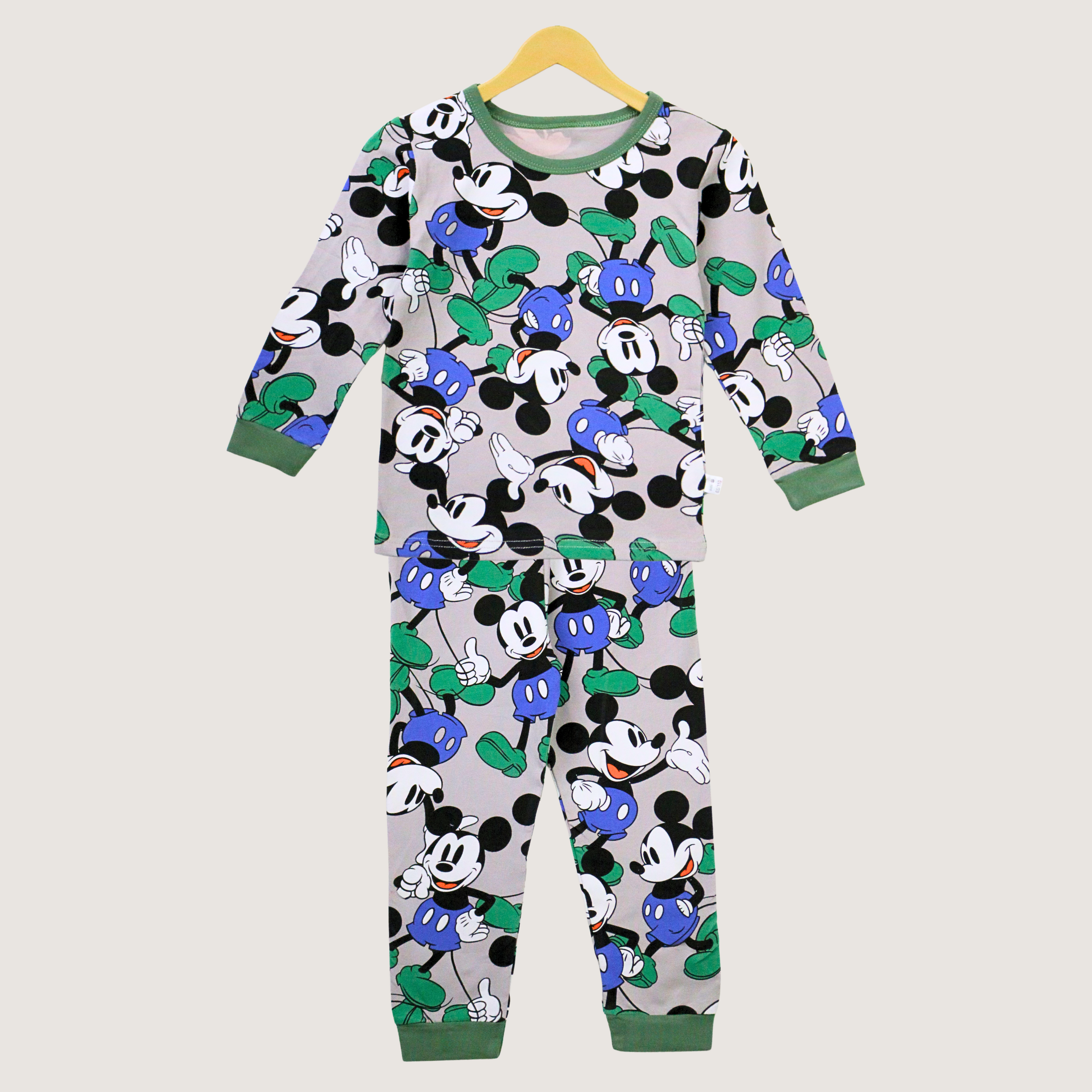 Children's pajama set with cartoon character pattern on a hanger against a light gray background