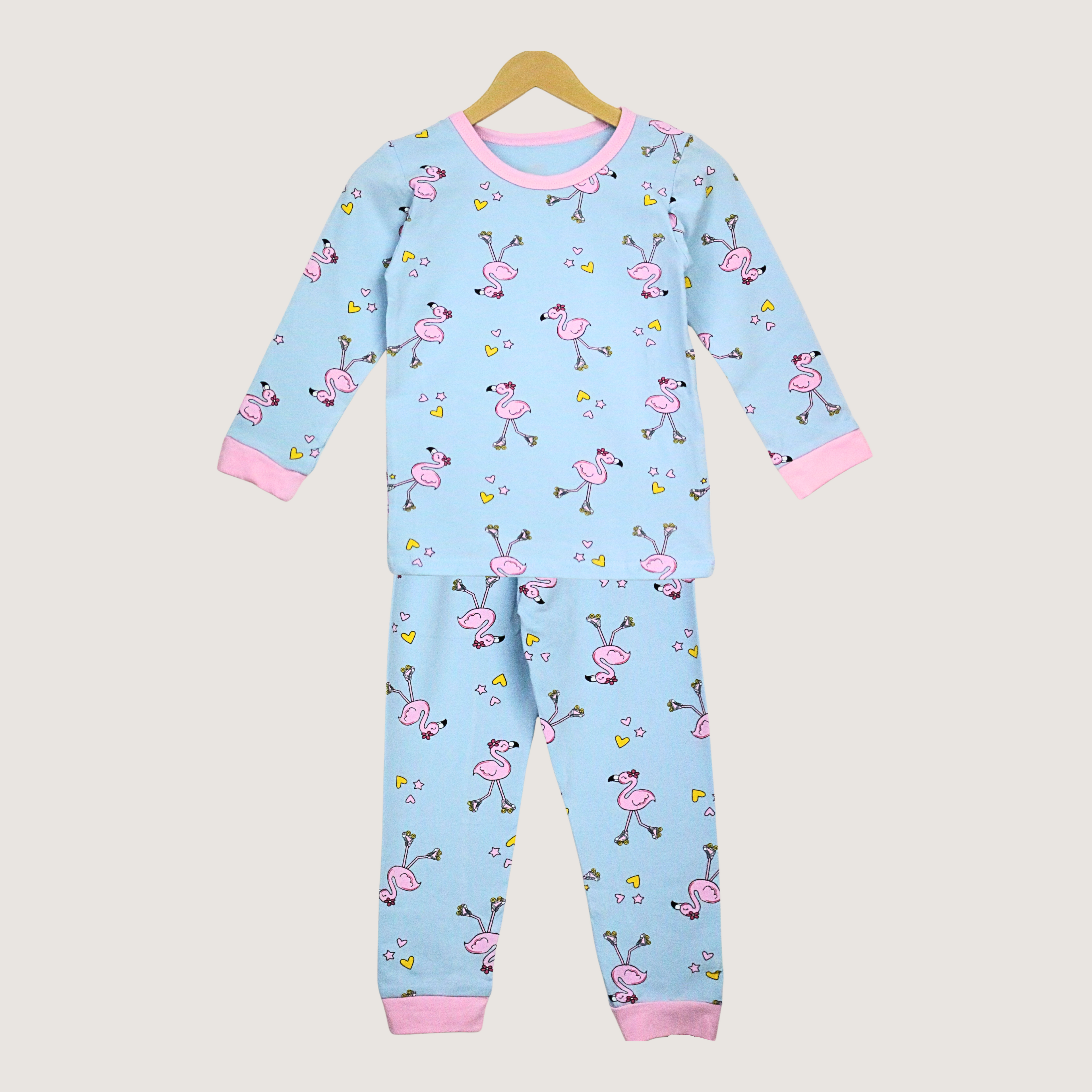 Children's onesie with flamingo pattern on a beige background