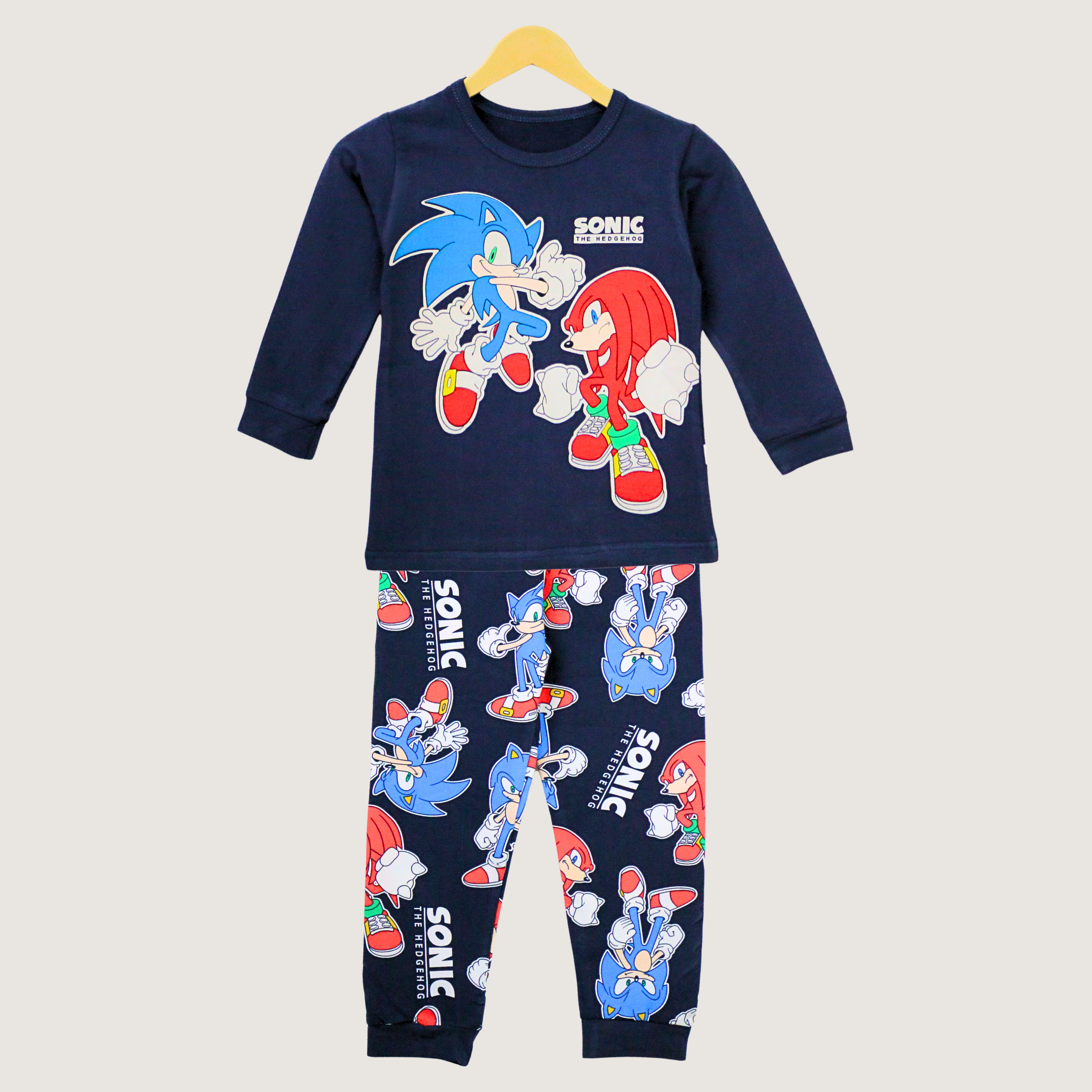Children's pajama set with Sonic the Hedgehog design on a hanger against a light gray background