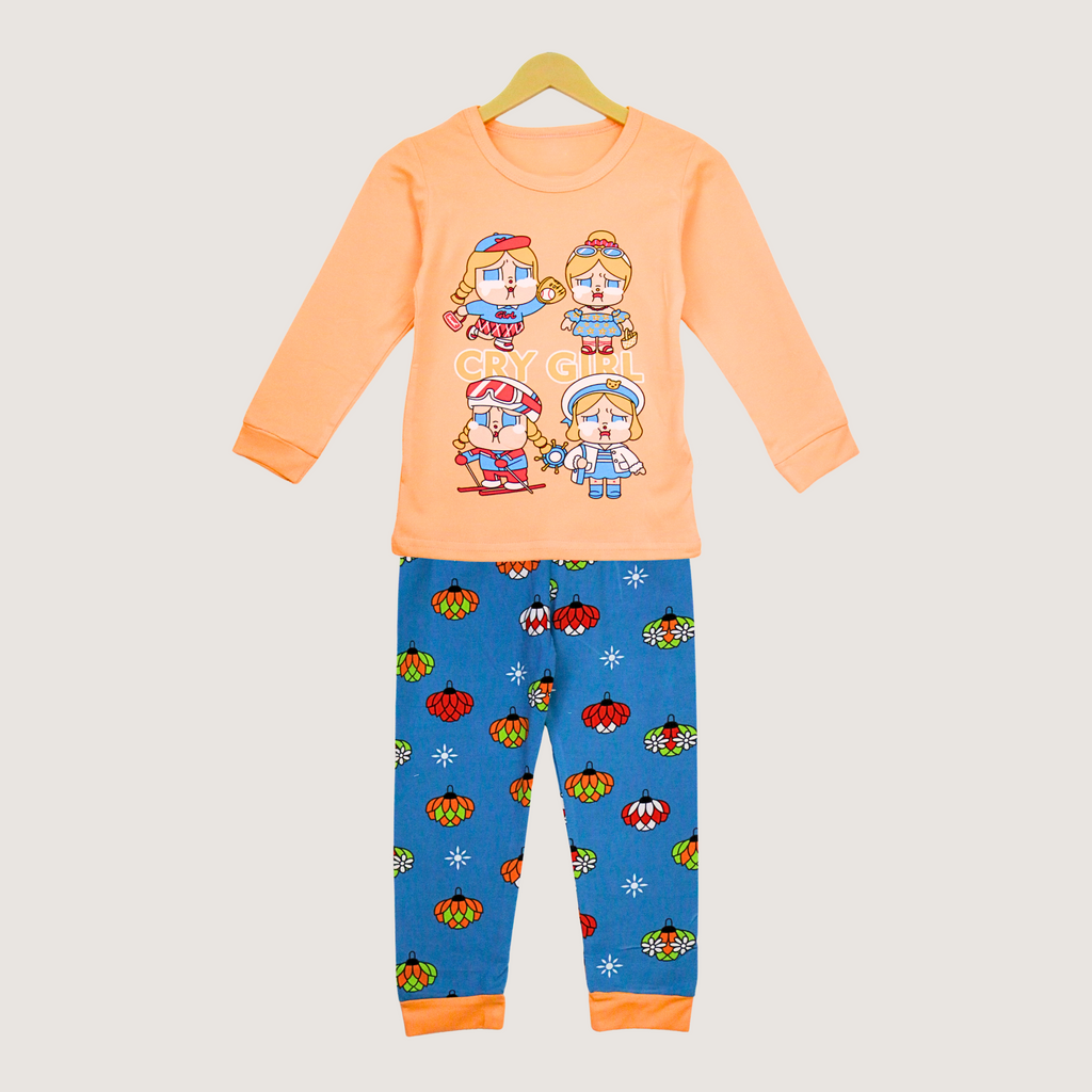 Children's pajama set with orange top and blue pants on a hanger against a light gray background