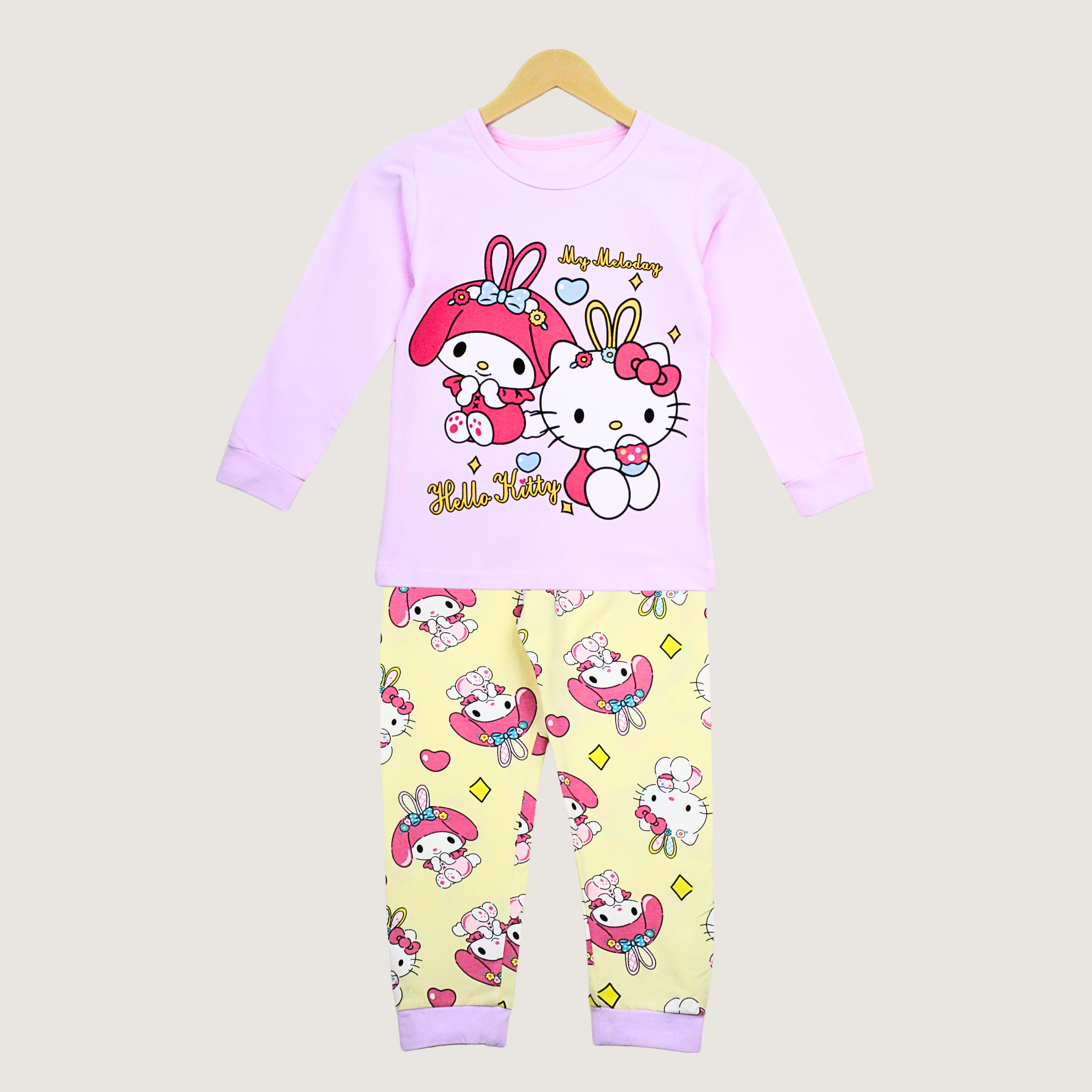 Children's pajama set with Hello Kitty design on a beige background