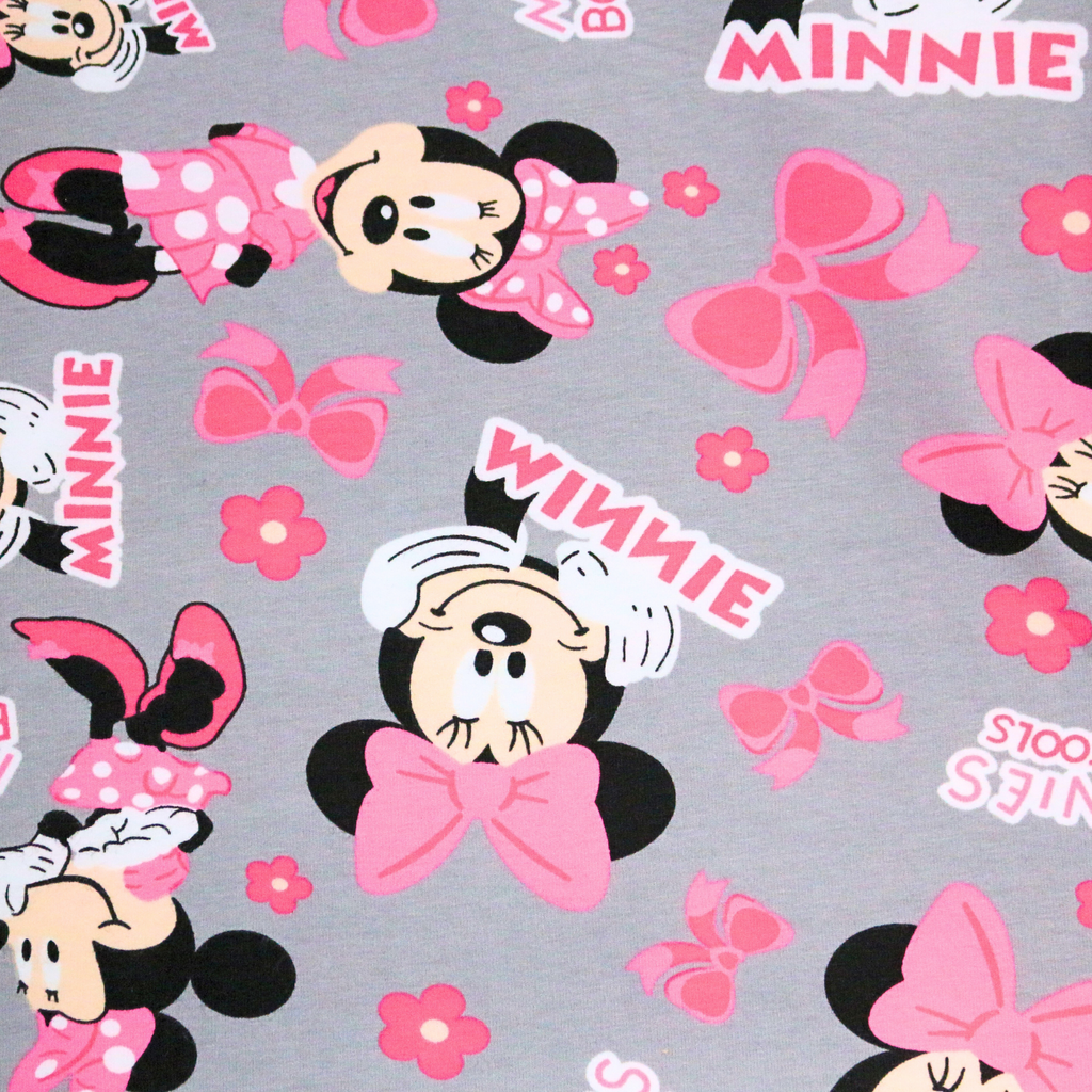 Pattern of cartoon characters with pink bows and flowers on a gray background
