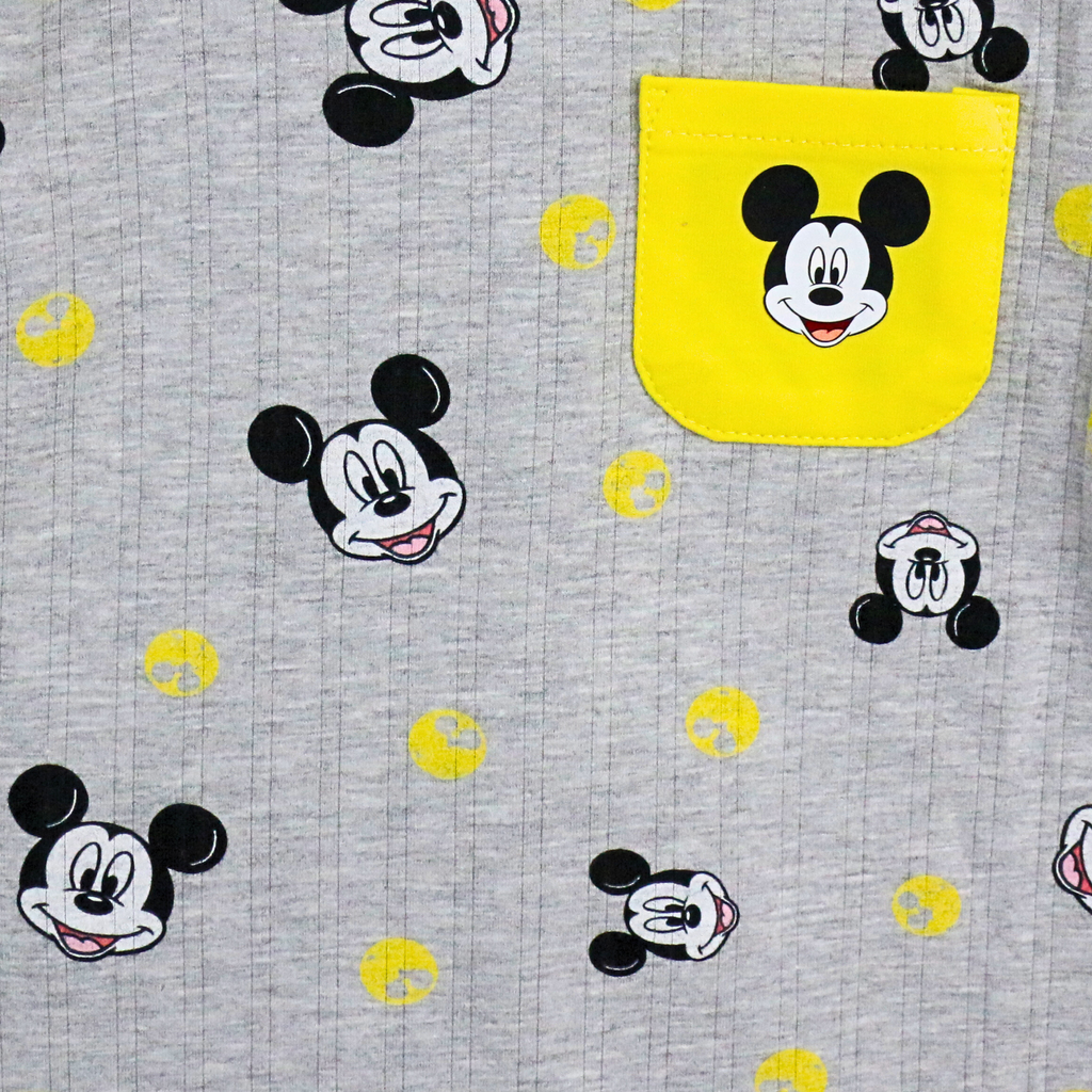 Gray fabric with Mickey Mouse faces and yellow shapes on a gray background