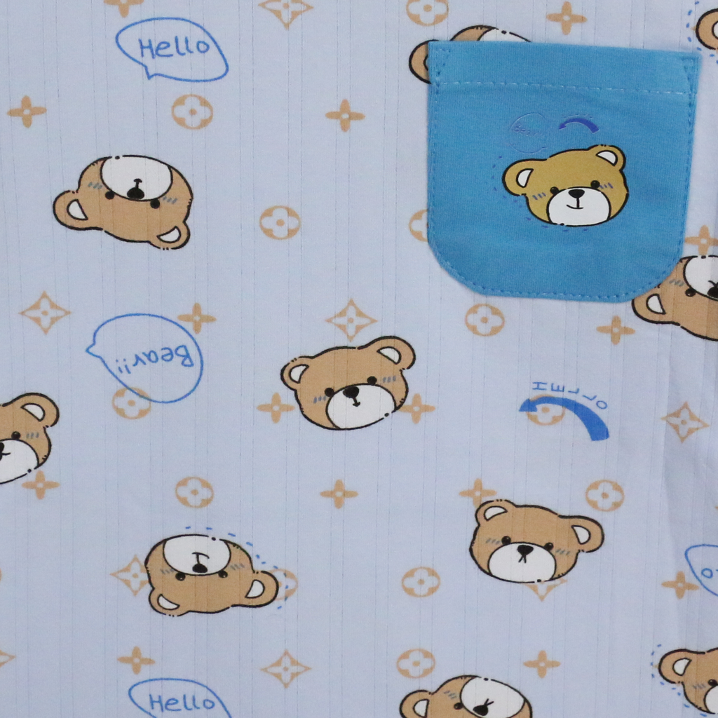 Baby blanket with teddy bear pattern and blue pocket on light blue background