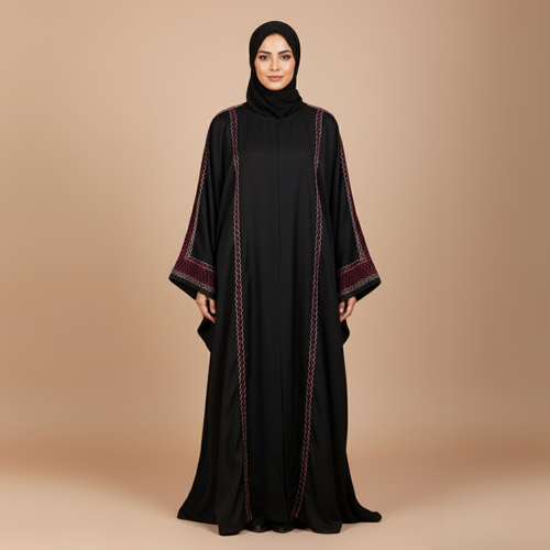 Woman wearing a black abaya with red embroidery on a beige background