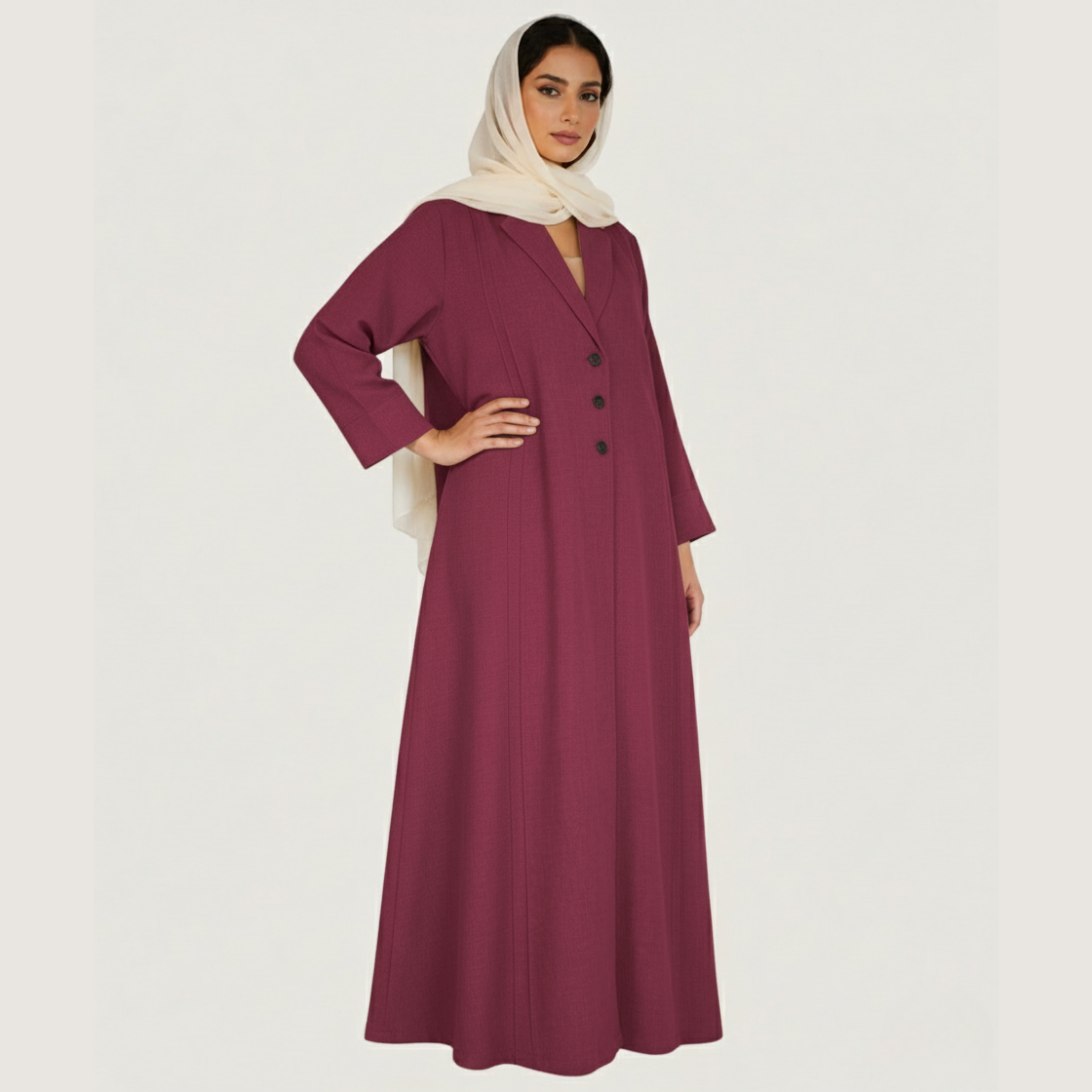 Woman wearing a long burgundy dress with a plain background
